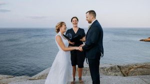 Sarah Anderson laughing as she officiates a wedding with her business, East Coast Pop Up Weddings in Nova Scotia.