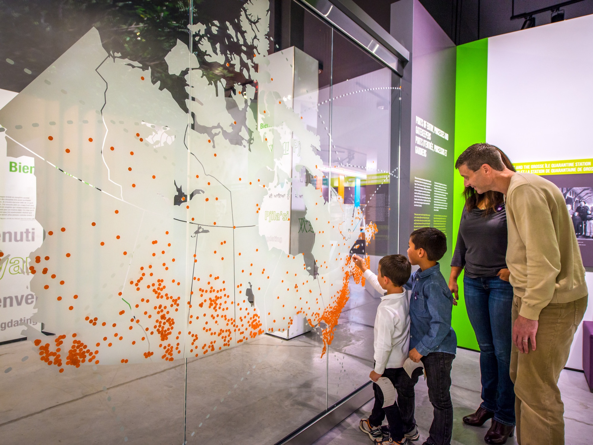 A family is viewing a map of Canada at the Canadian Museum of Immigration at Pier 21 in Halifax, Nova Scotia