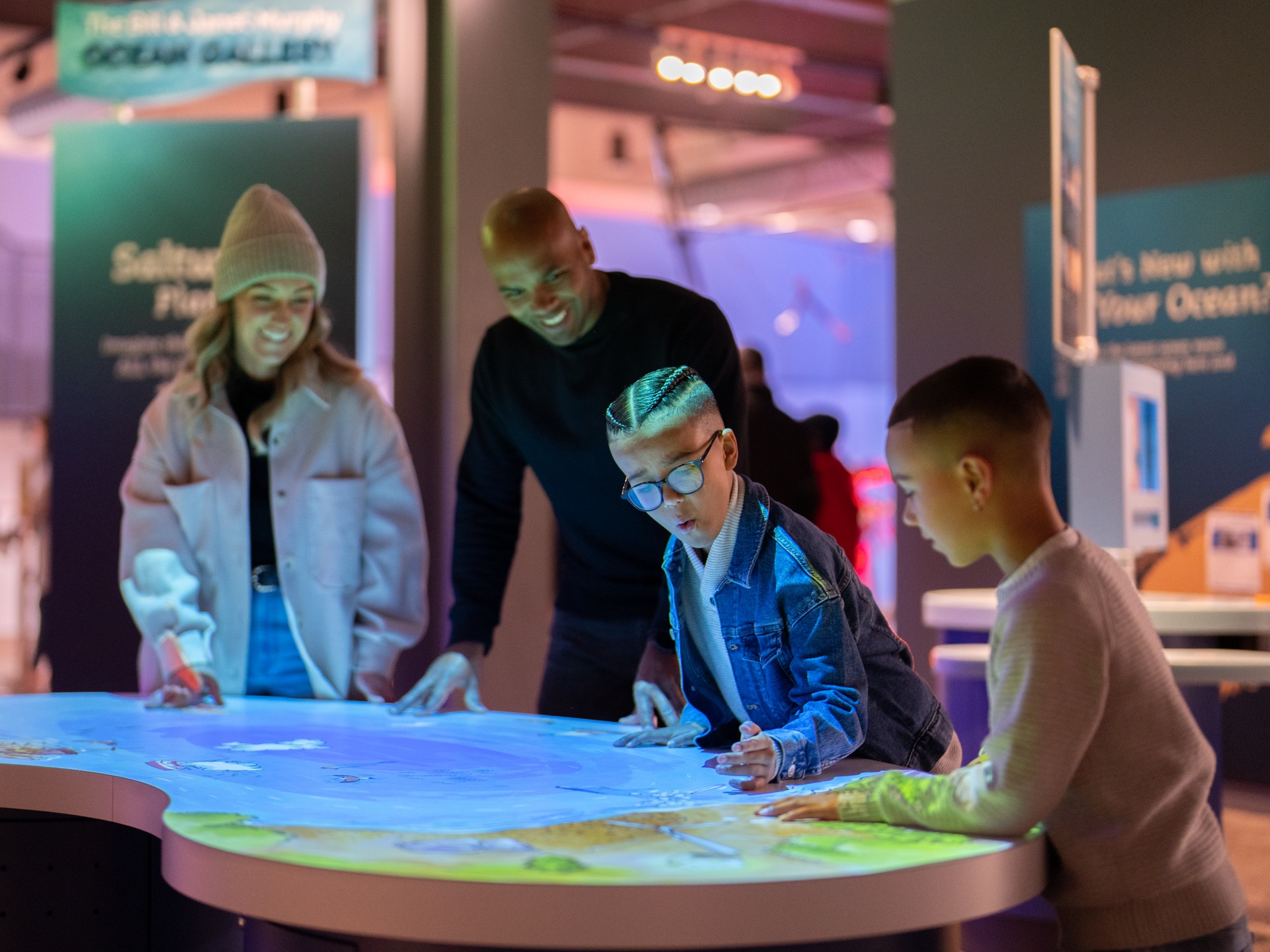 A family having fun playing and learning together at the discovery Center, a fun science museum in downtown Halifax, Nova Scotia