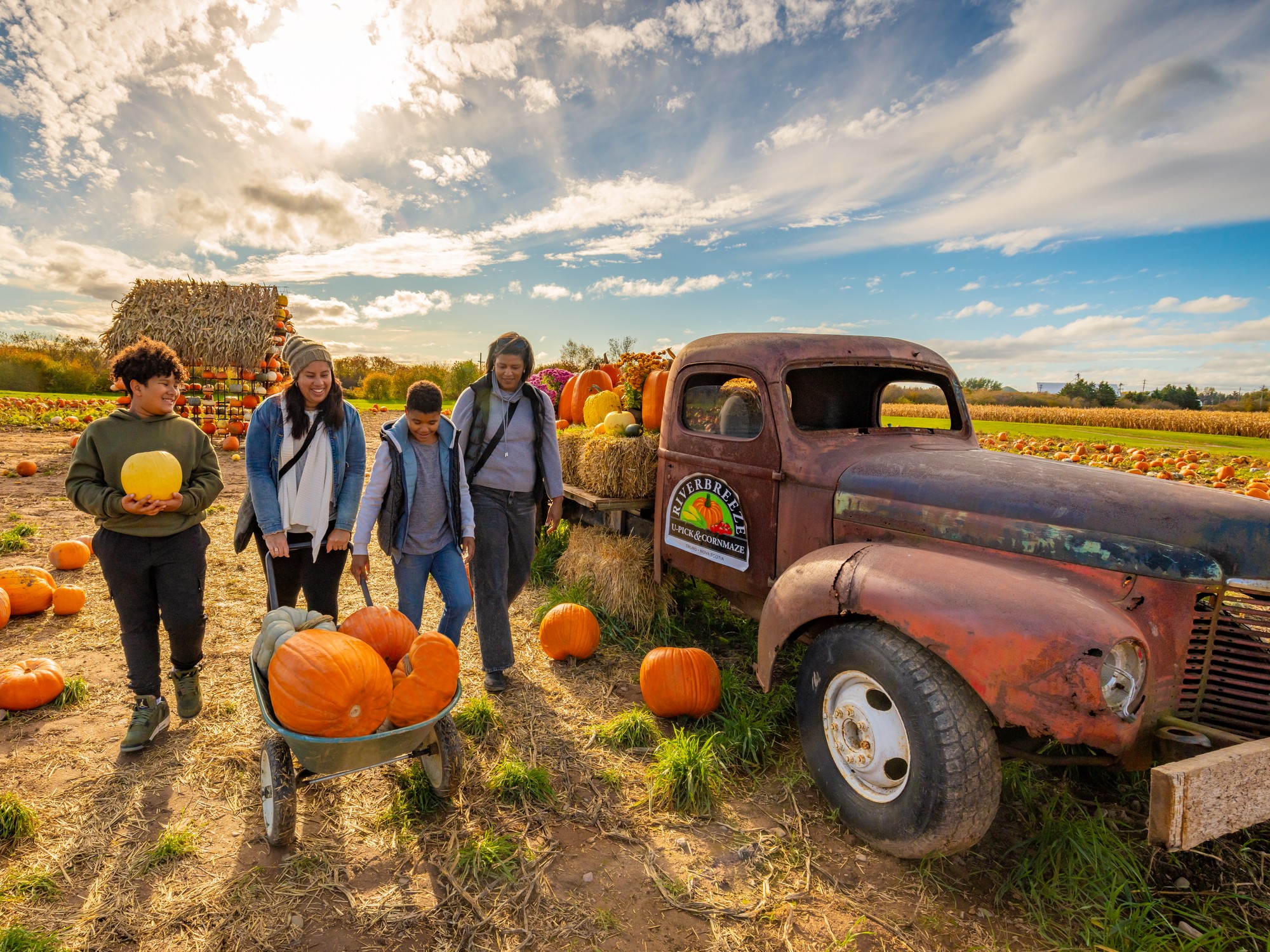 Parents and kids pick pumpkins at Riverbreeze Farm in Nova Scotia