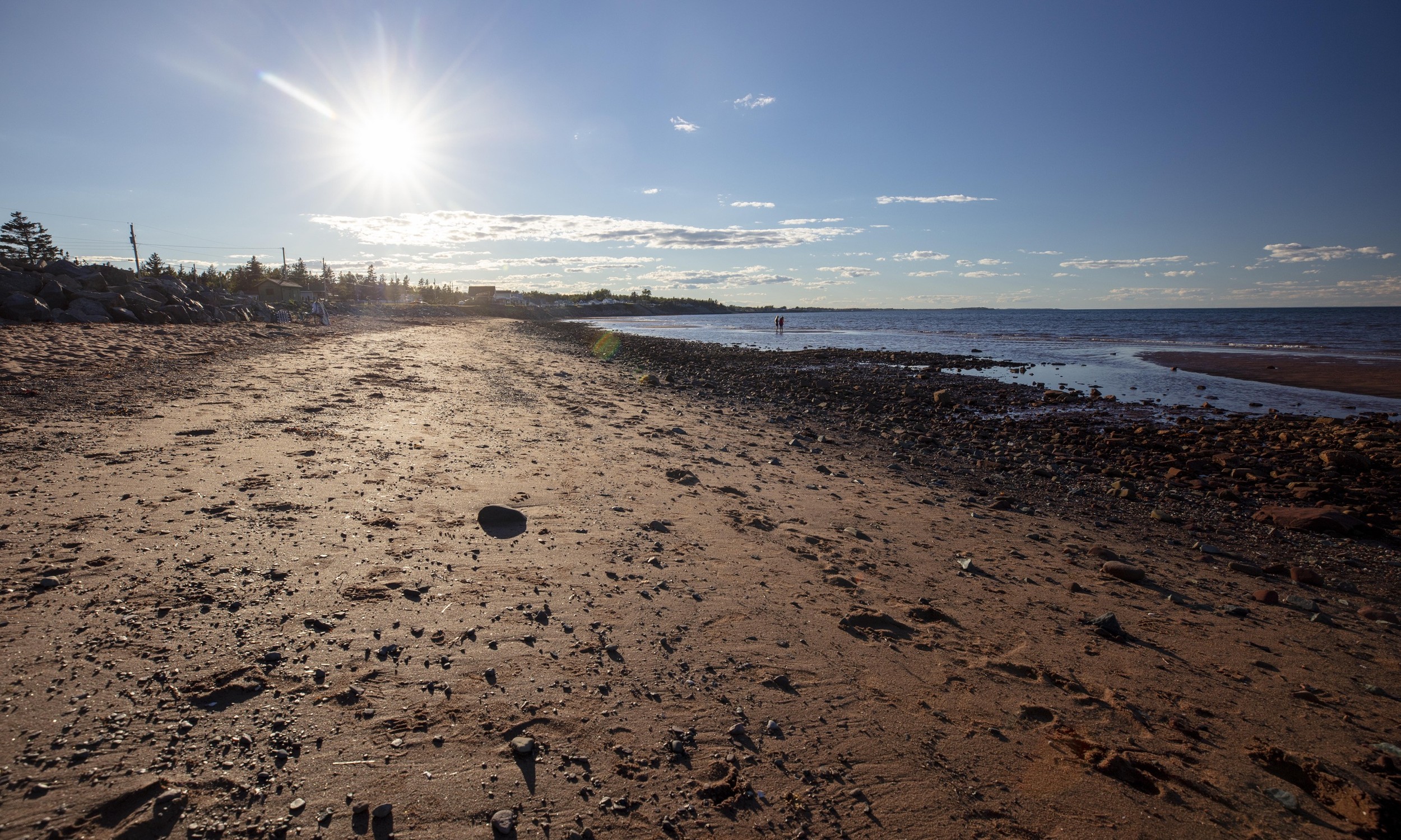 The sun shines down on a sandy Heather Beach in Nova Scotia