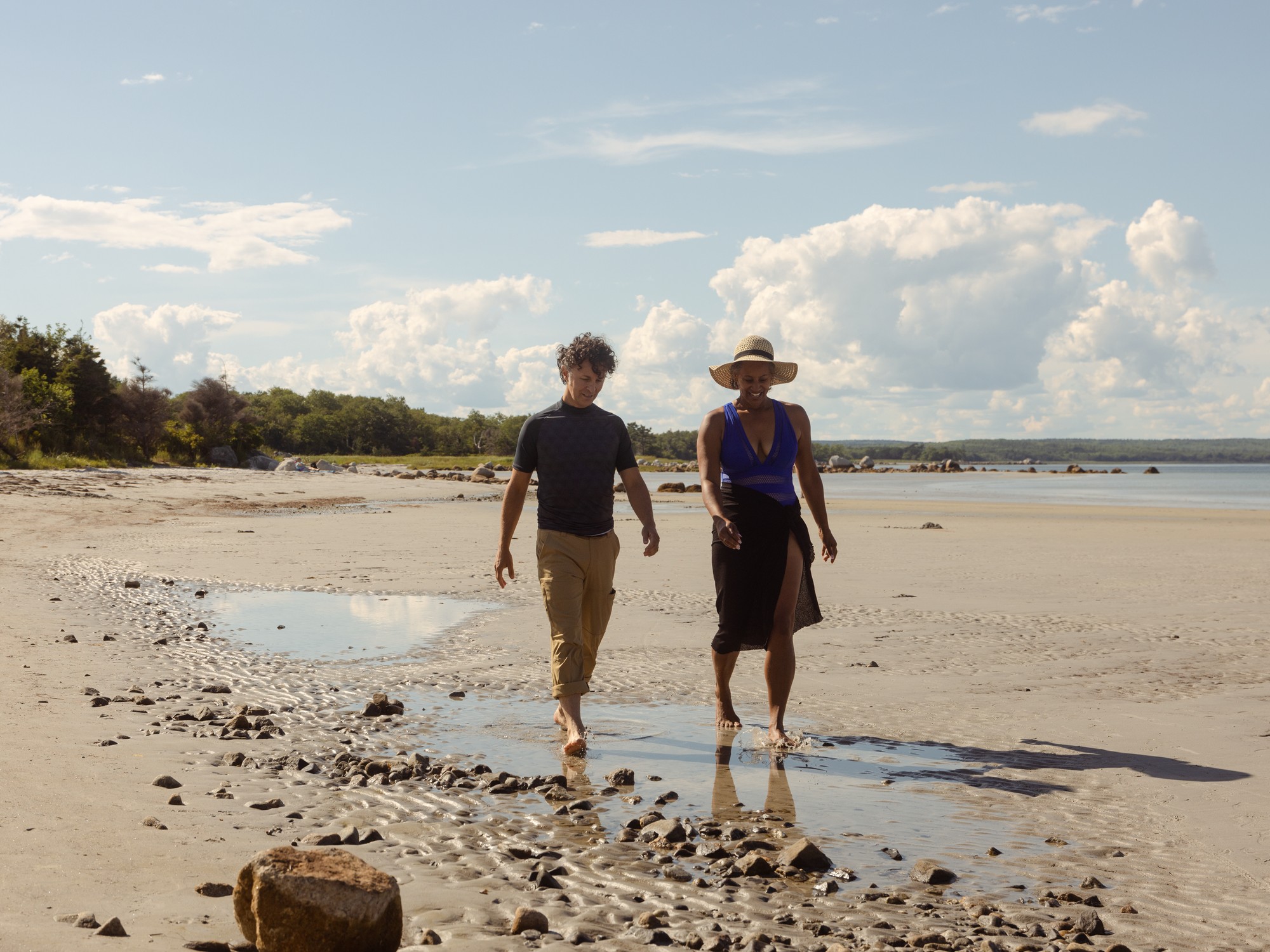Two people walk along the beach at Thomas Raddall Provincial Park in Nova Scotia