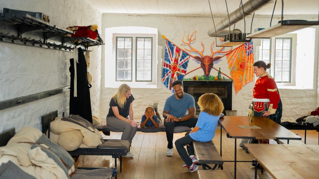 A family on a private "Living History" experience in the soldiers' bunks with a soldier at Halifax Citadel National Historic Site in Halifax, Nova Scotia