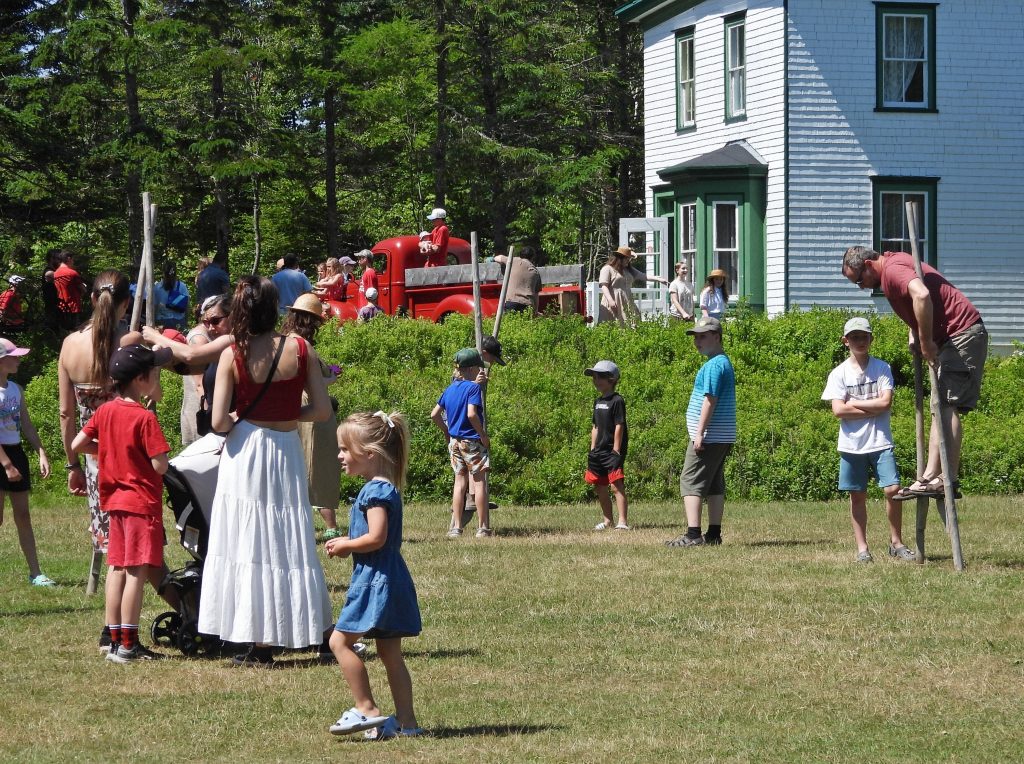 A group of people play lawn games at the Dominion Day “Old Time” Village Fair at Memory Lane in Nova Scotia