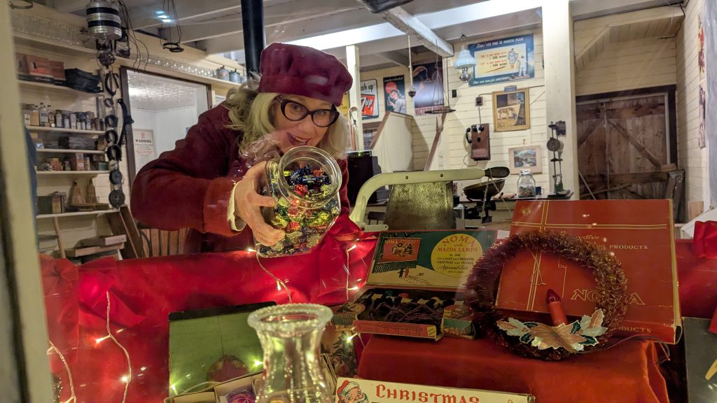 A lady looks at a snowglobe at the Memory Lane Christmas Walk in Nova Scotia