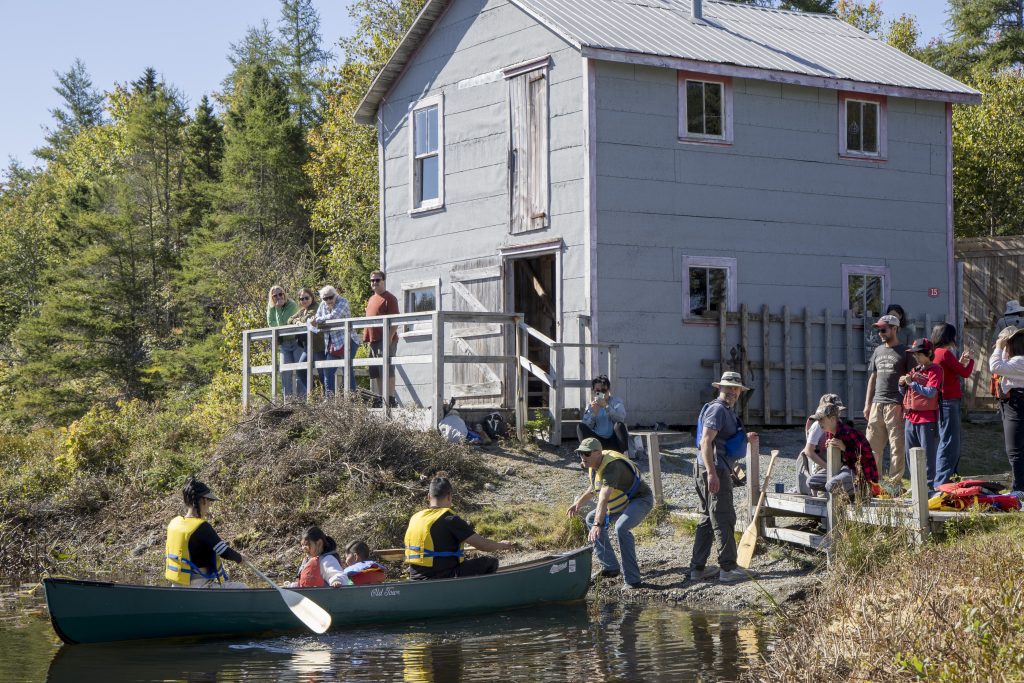 A group of people wearing lifejackets launch a boat at the Nova Scotia Forest Festival at Memory Lane in Nova Scotia