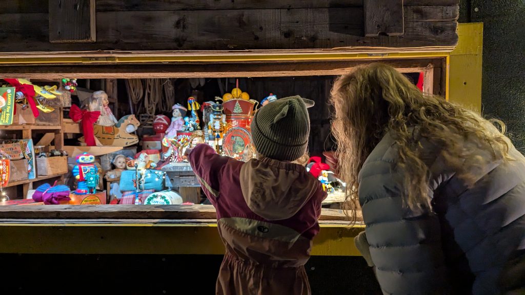 A parent and child look at a Christmas scene during the Memory Lane Christmas Walk in Nova Scotia