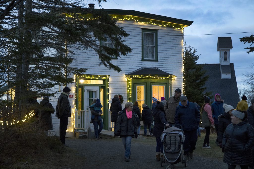 A group of people standing outside the general store during the Memory Lane Christmas Walk in Nova Scotia