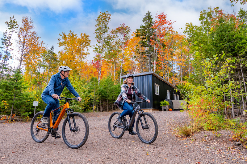 Two people biking in the fall at Seek Wilderness Accommodations