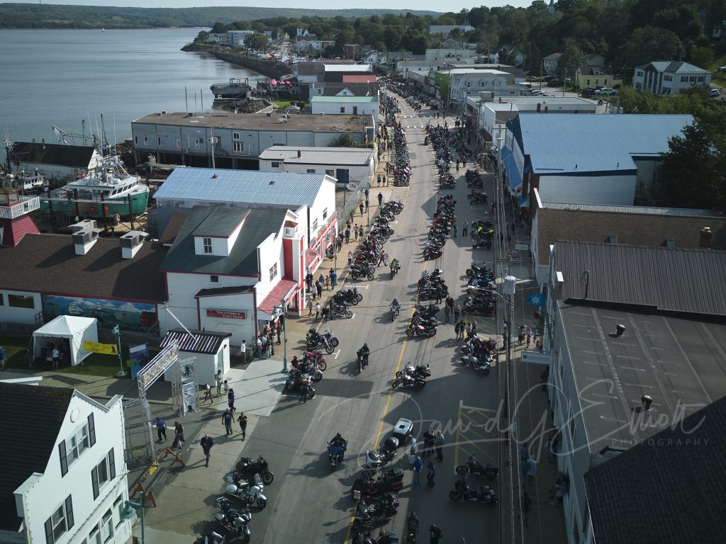 An aerial view of particiapnts filling the street as part of the Wharf Rat Rally in Digby, Nova Scotia