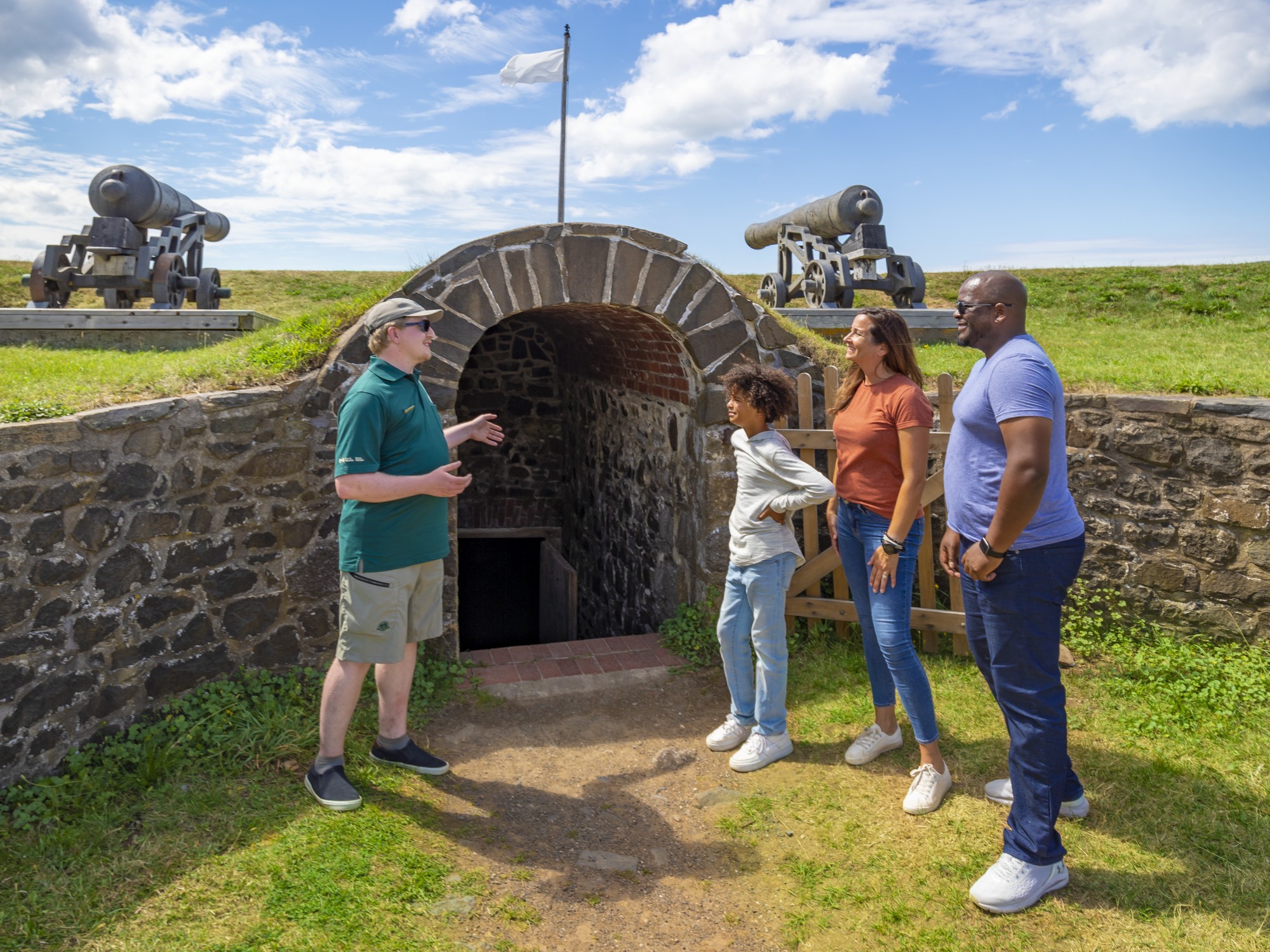 A family speaks with an interpreter at Fort Anne National Historic Site in Annapolis Royal, Nova Scotia