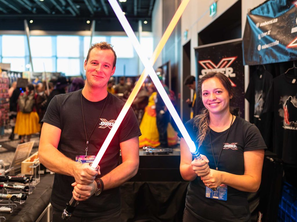 Two people holding Star Wars lightsabers in the marketplace during Hal-Con in Halifax Nova Scotia