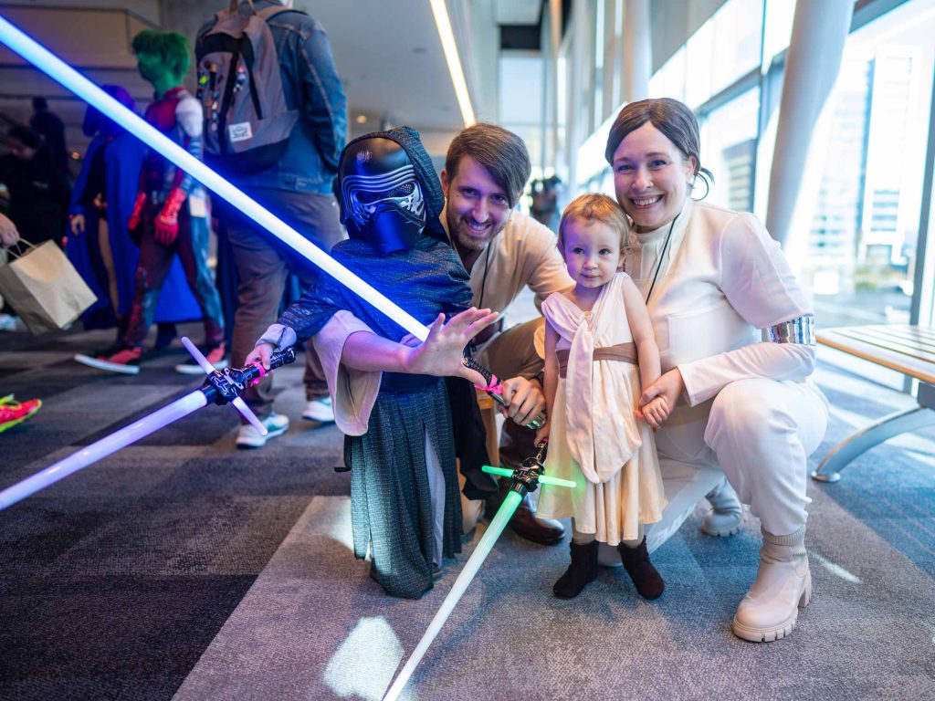 Two parents and their two small children dressed as Star Wars characters pose for a photo in the Halifax Convention Centre during Hal-Con in Halifax, Nova Scotia