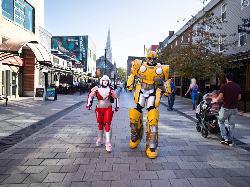 Two people in elaborate Transformers costumes walking on Argyle Street in downtown Halifax during the annual Hal-Con convention in Halifax Nova Scotia