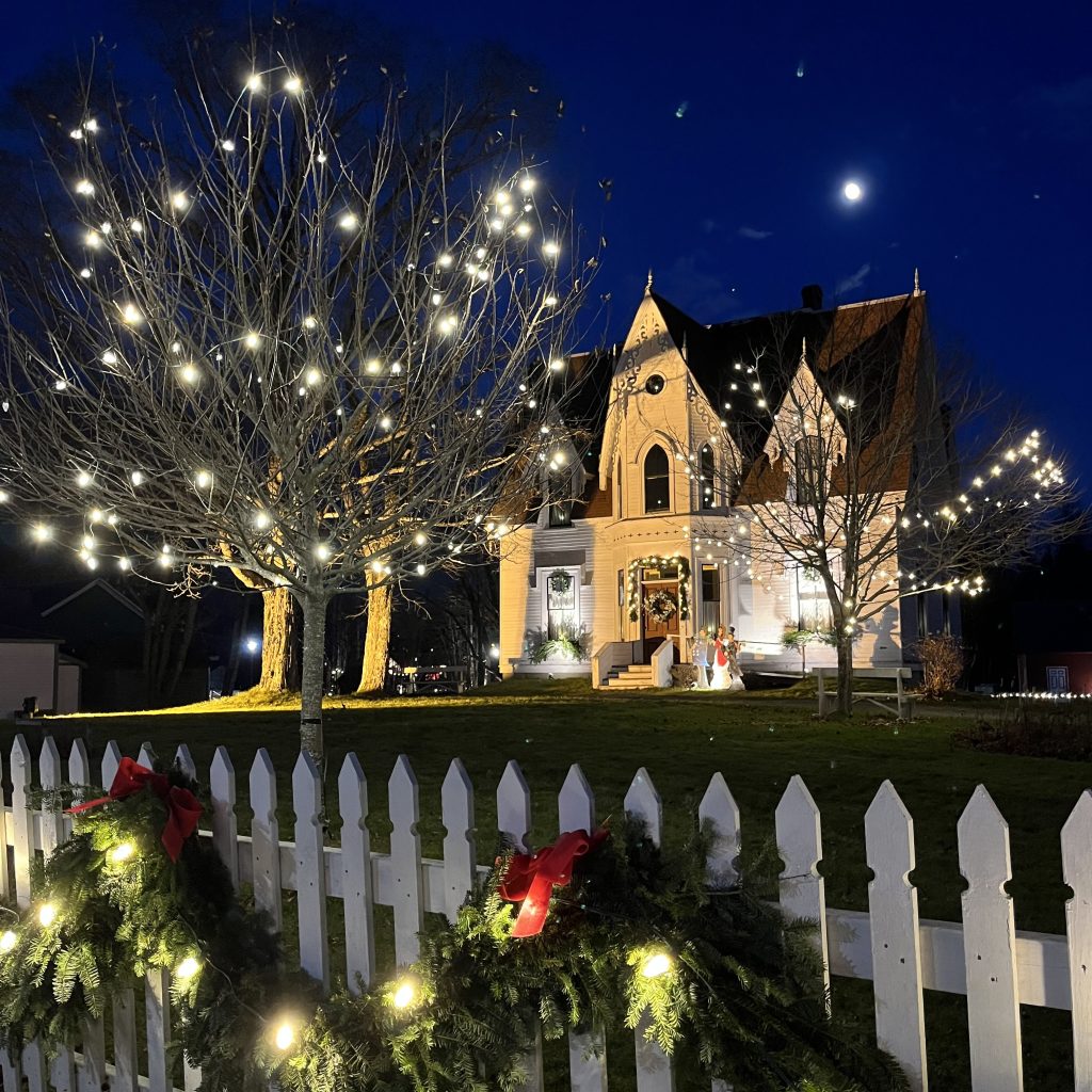 Christmas at Sherbrooke Village in Nova Scotia lit up and decorated at night in Nova Scotia