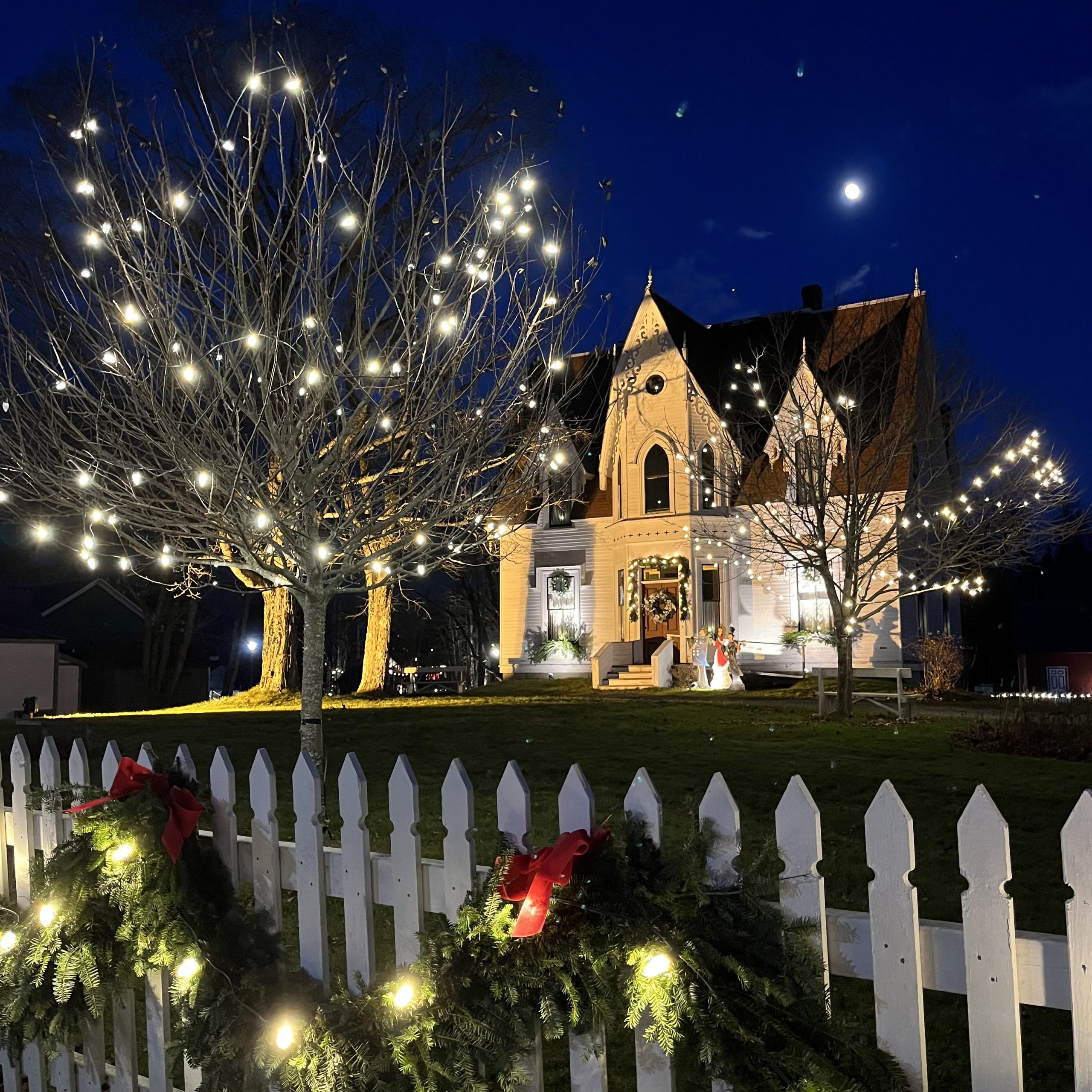 Christmas at Sherbrooke Village in Nova Scotia lit up and decorated at night in Nova Scotia