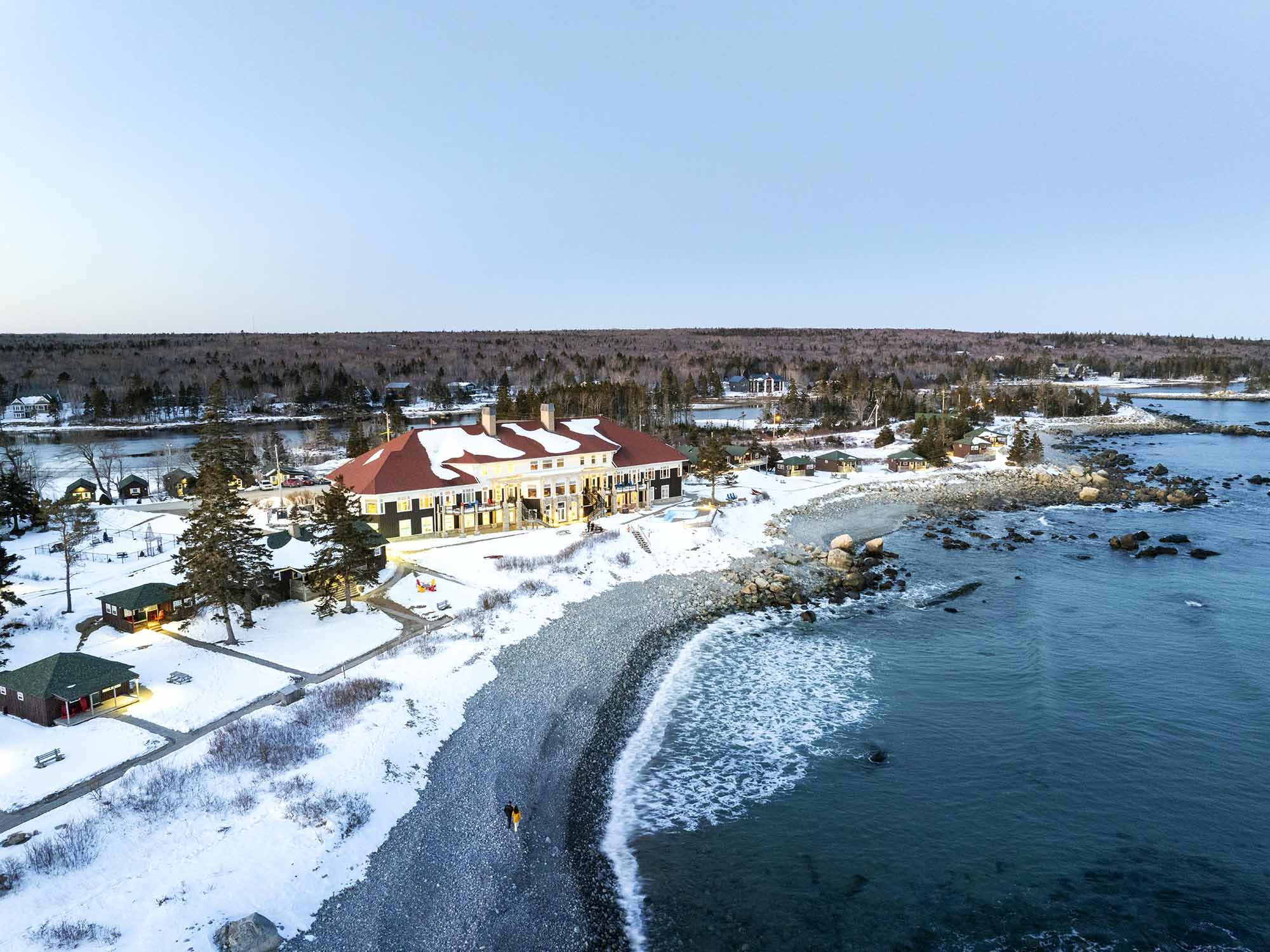 Drone view over the beach and main lodge at White Point Beach Resort near Liverpool, Nova Scotia in the wintertime.
