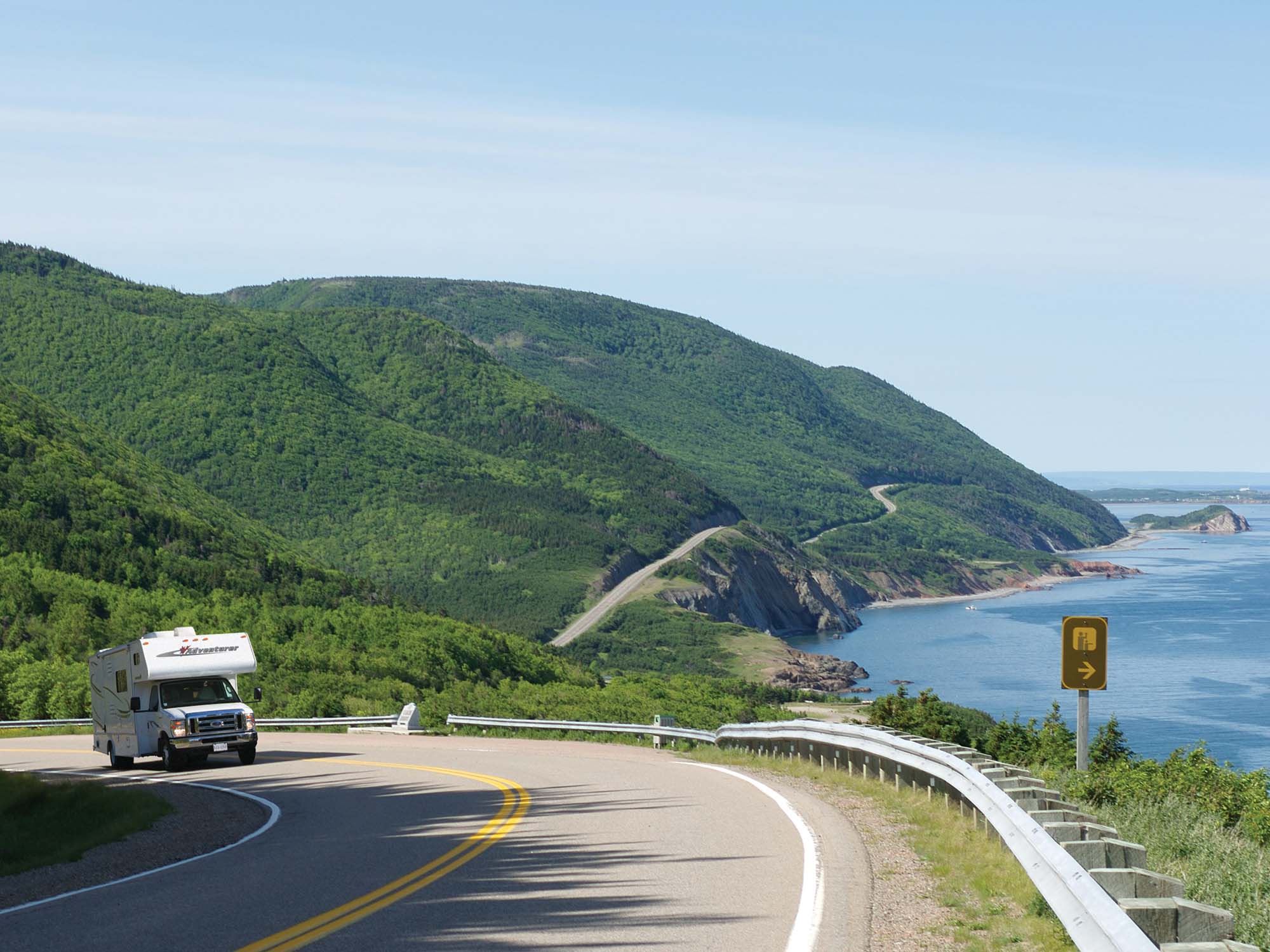 An RV Camper driving clockwise on the Cabot Trail between Cheticamp and Eel Brook in Nova Scotia.