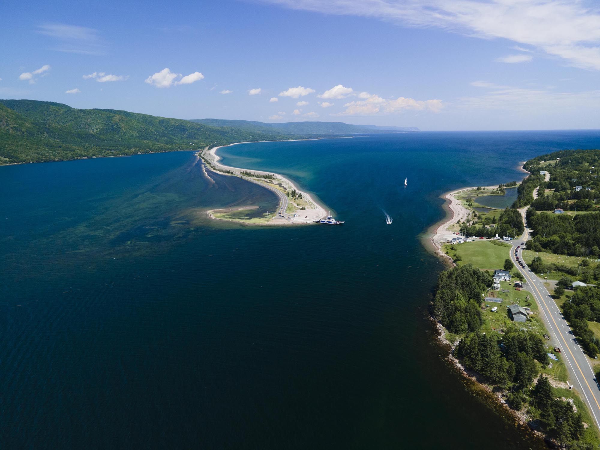 Drone view of the Englishtown ferry on the Jersey Cove side of the channel that connects St. Ann's Bay and the open Atlantic Ocean near Baddeck. This connects to the Cabot Trail in Cape Breton, Nova Scotia