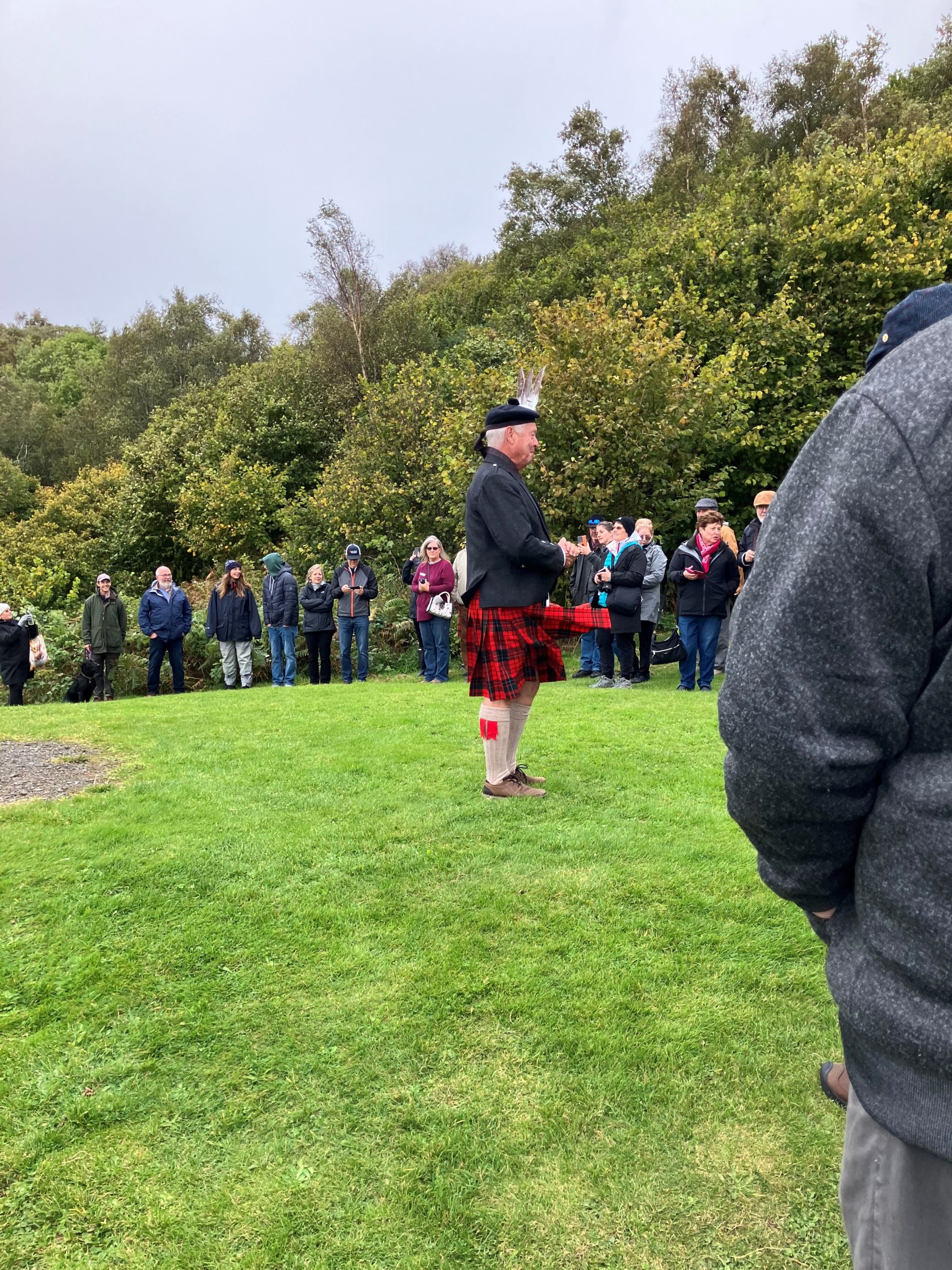 A man playing bagpipes at the 2024 International Gathering of Clan MacNeacail in Isle of Skye.
