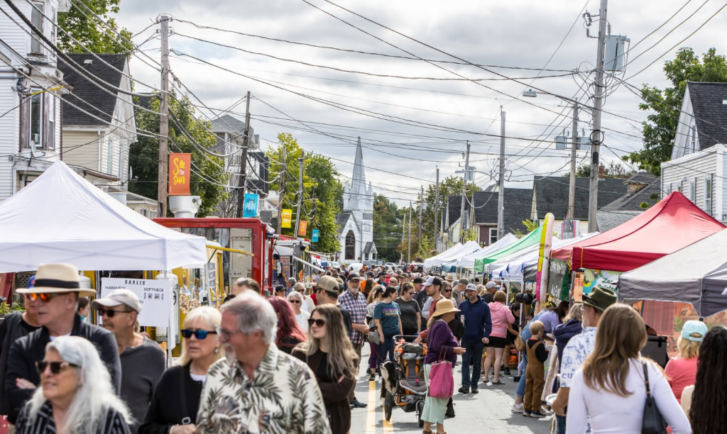 A street full of vendors and people at the Windsor Garlic Fest in Nova Scotia