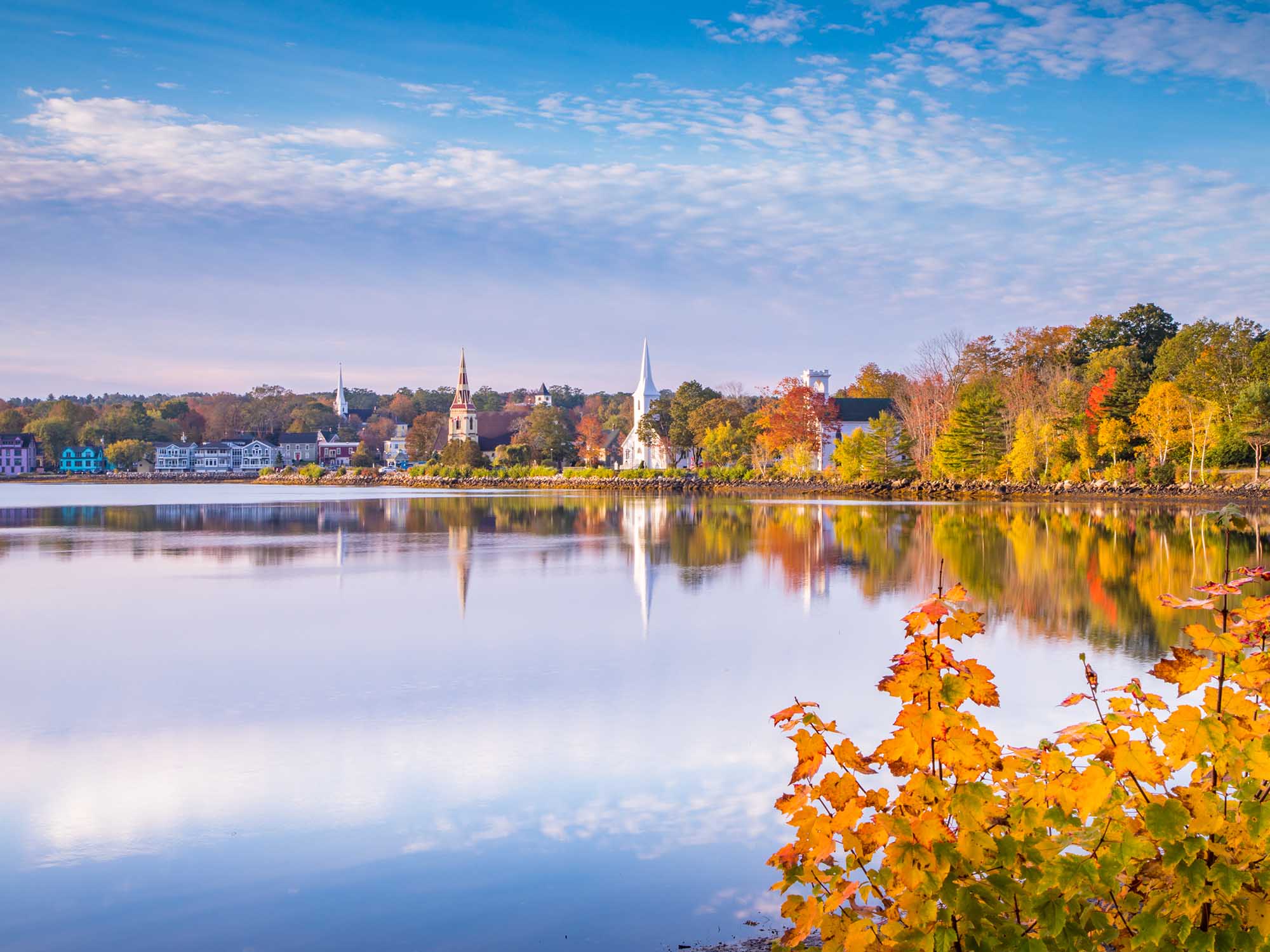 View of the Three Churches reflecting on the water in Mahone Bay in Autumn in Nova Scotia