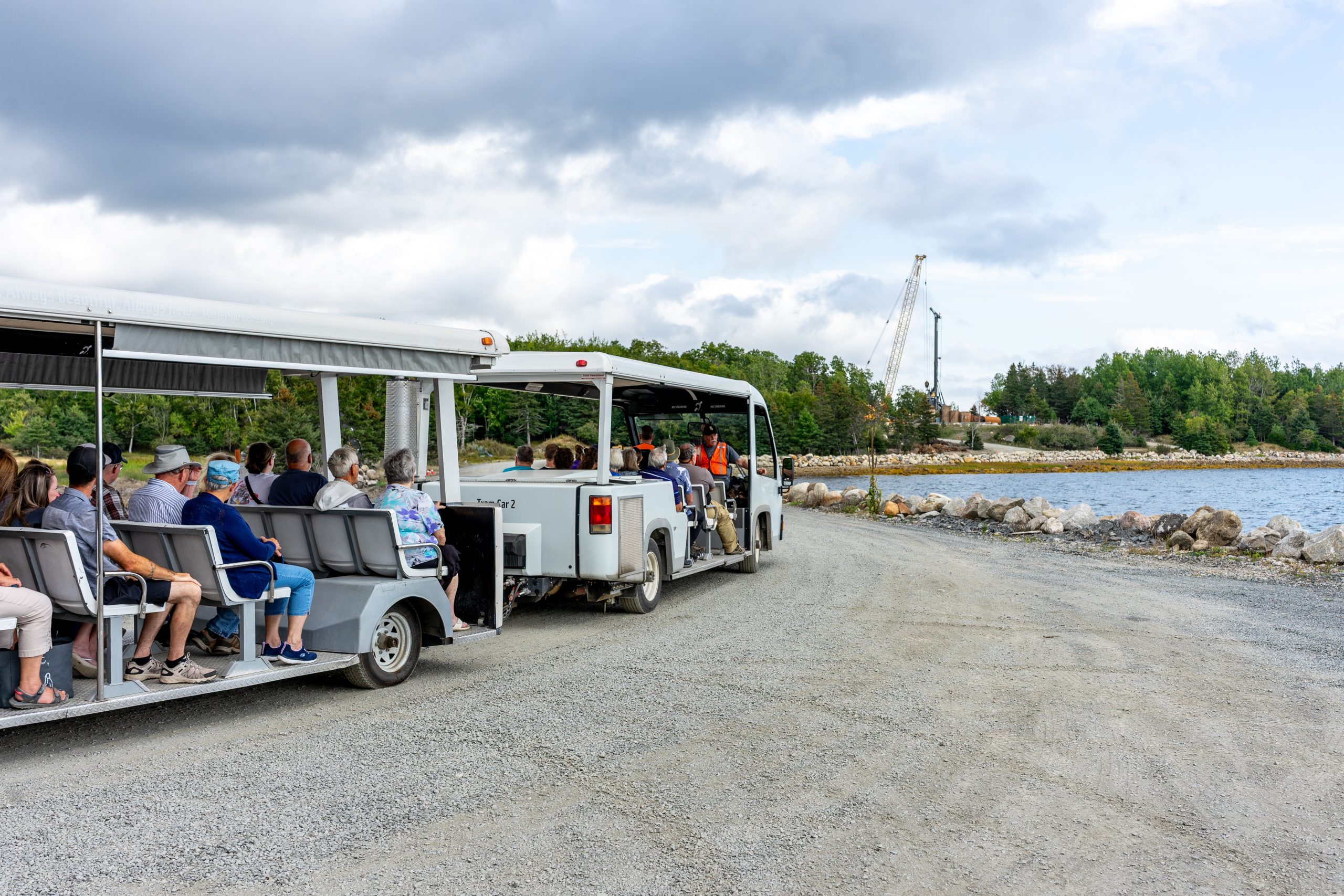 Tour participants aboard the Money Pit Express tram on a guided tour of sites on Oak Island in Nova Scotia.