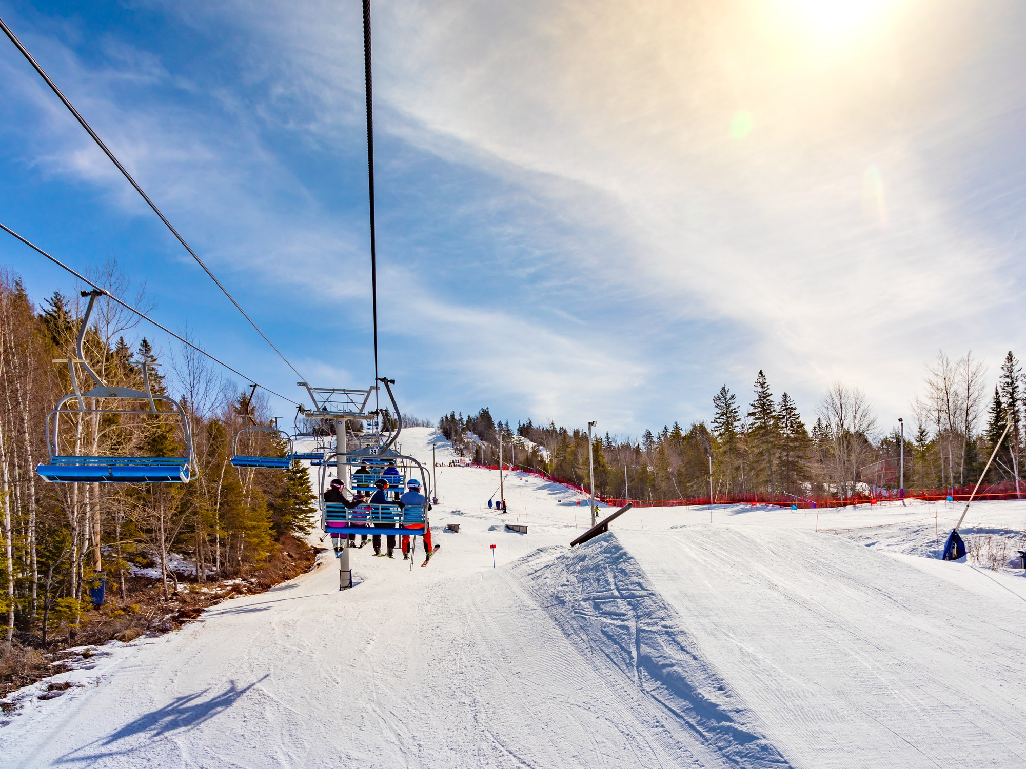 Skiers on a chair lift go up a mountain at Ski Wentworth in Nova Scotia