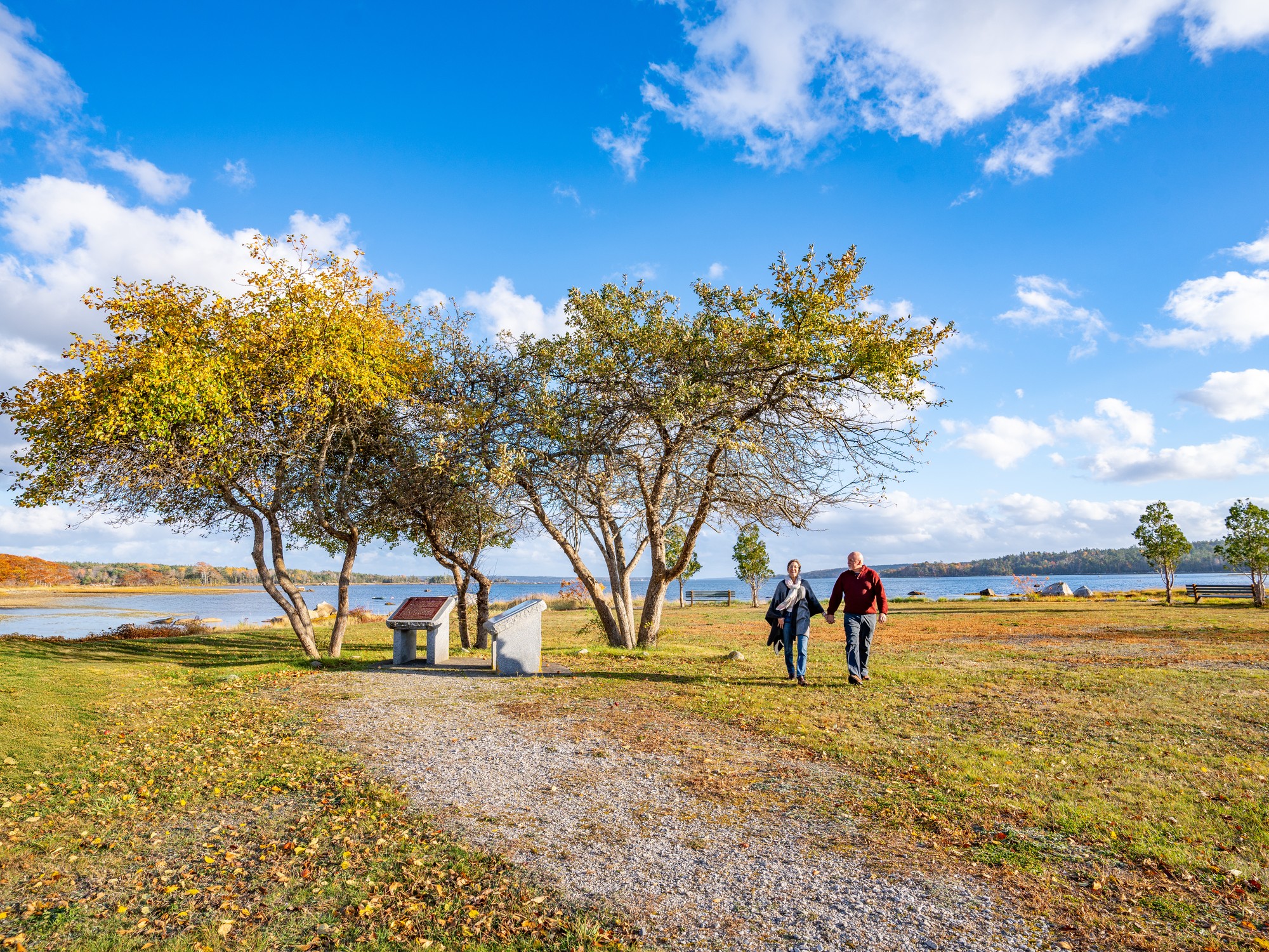 Two people walk along the Black Loyalist Heritage Trail during fall in Birchtown, Nova Scotia