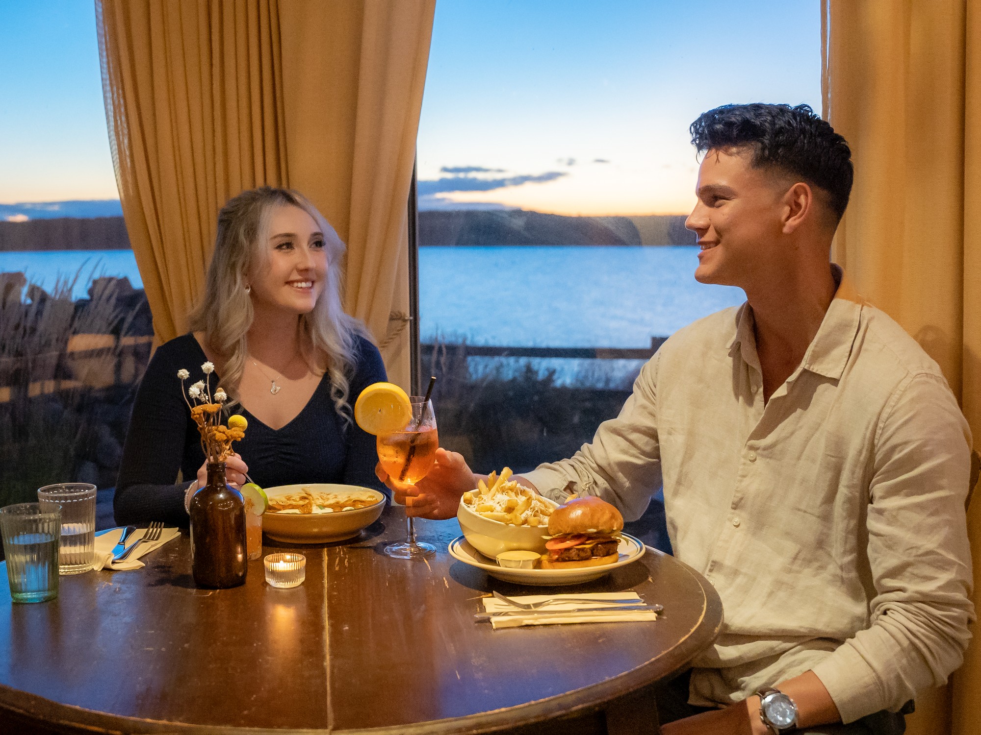 Two people dine at L'Abri Restaurant in Cheticamp, Nova Scotia