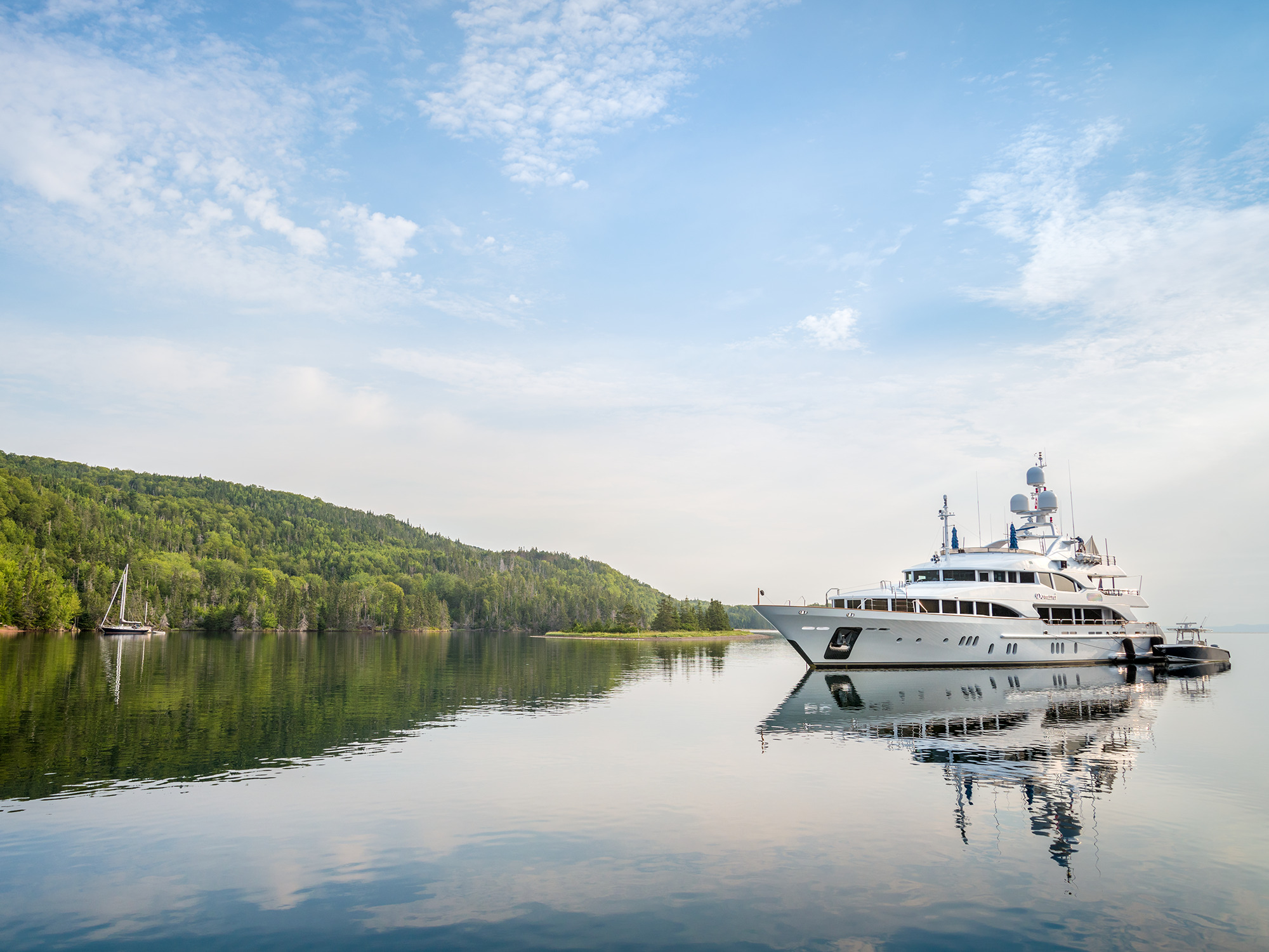 A yacht sits in the still waters of Baddeck Bay near Beinn Bhreagha, the summer home of inventor Alexander Graham Bell, on the Bras d'Or Lake in Cape Breton, Nova Scotia