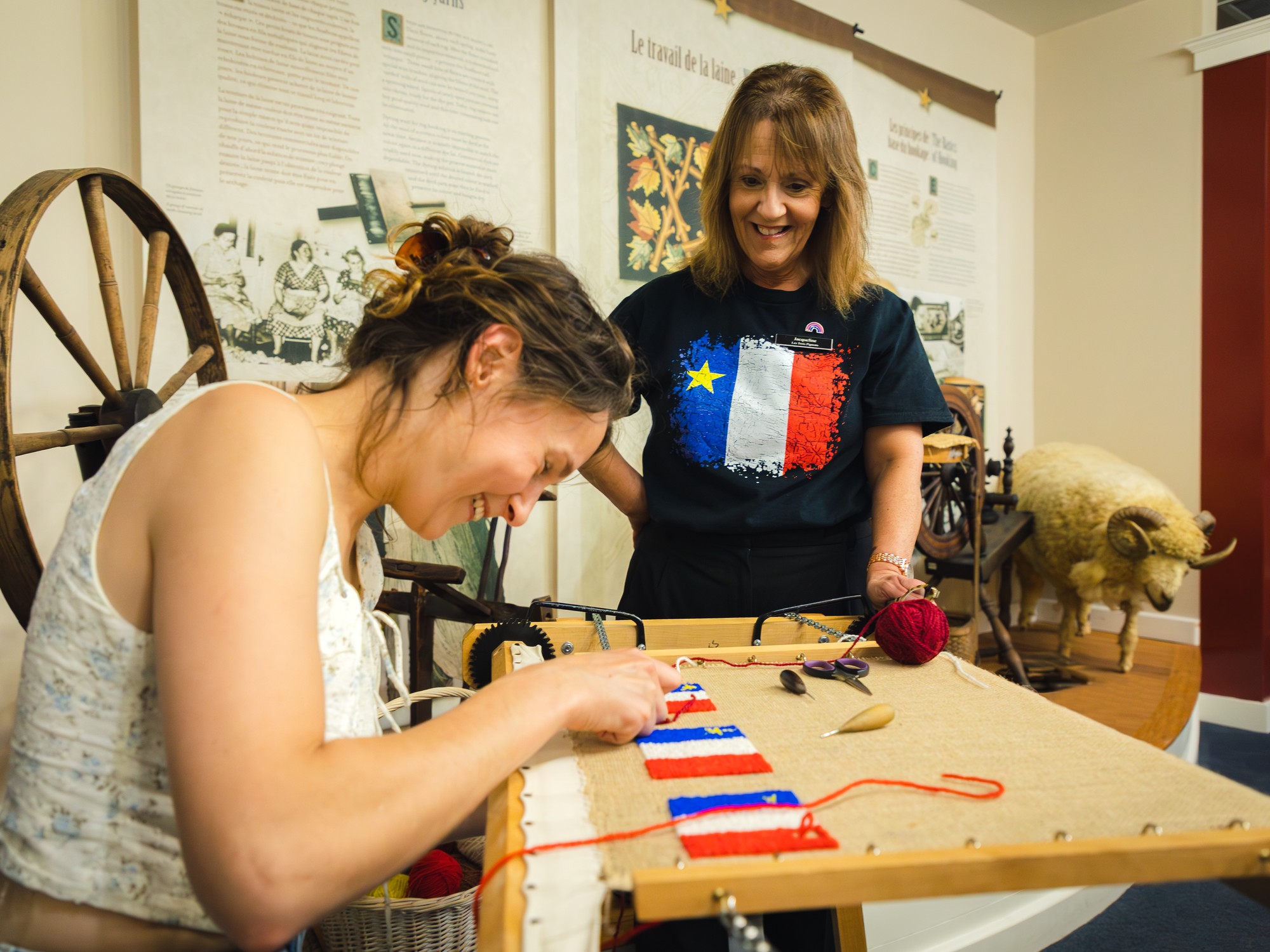 A woman hooks an Acadian flag at Les Trois Pignons in Cheticamp, Nova Scotia