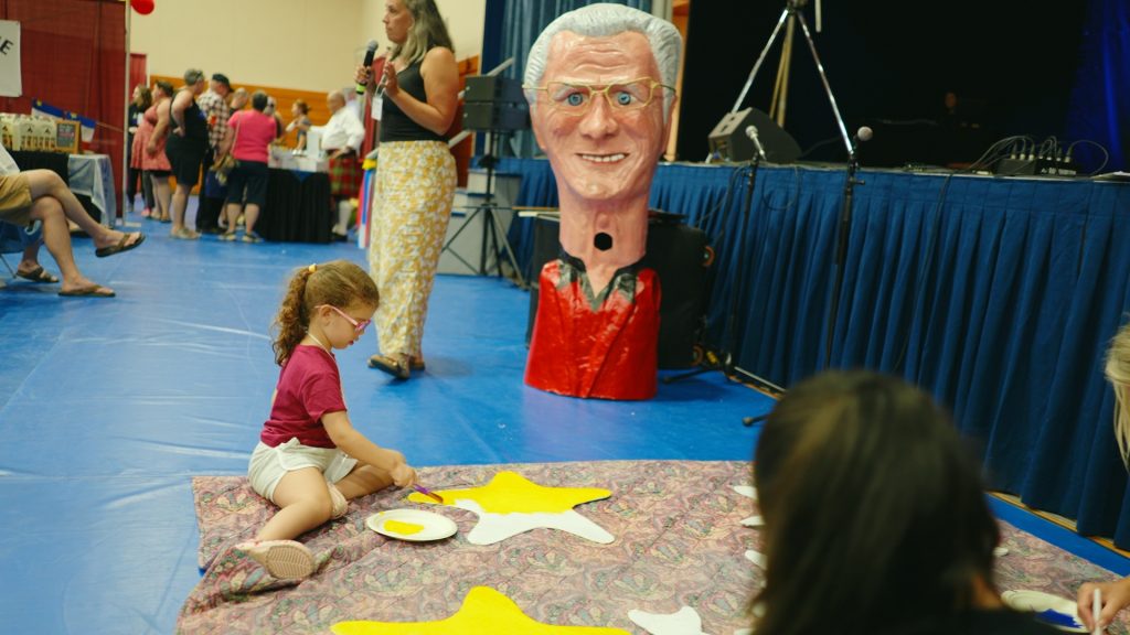 A girl works on a craft at the Expo Culturelle (Culture Expo) in Clare, Nova Scotia