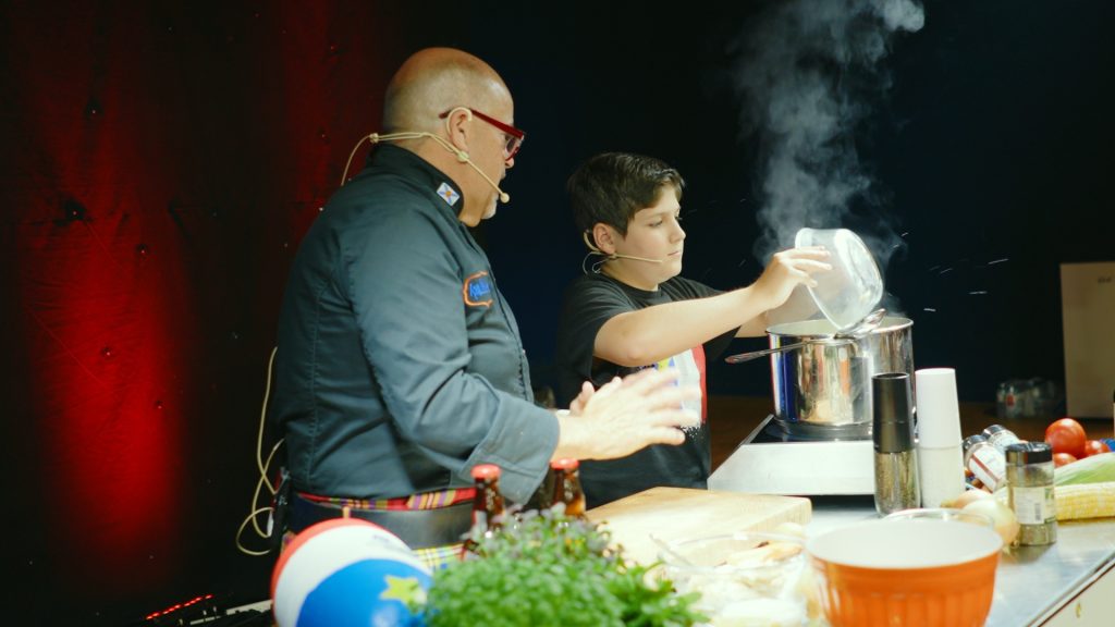 Two people cooking at the Expo Culturelle (Culture Expo) in Clare, Nova Scotia
