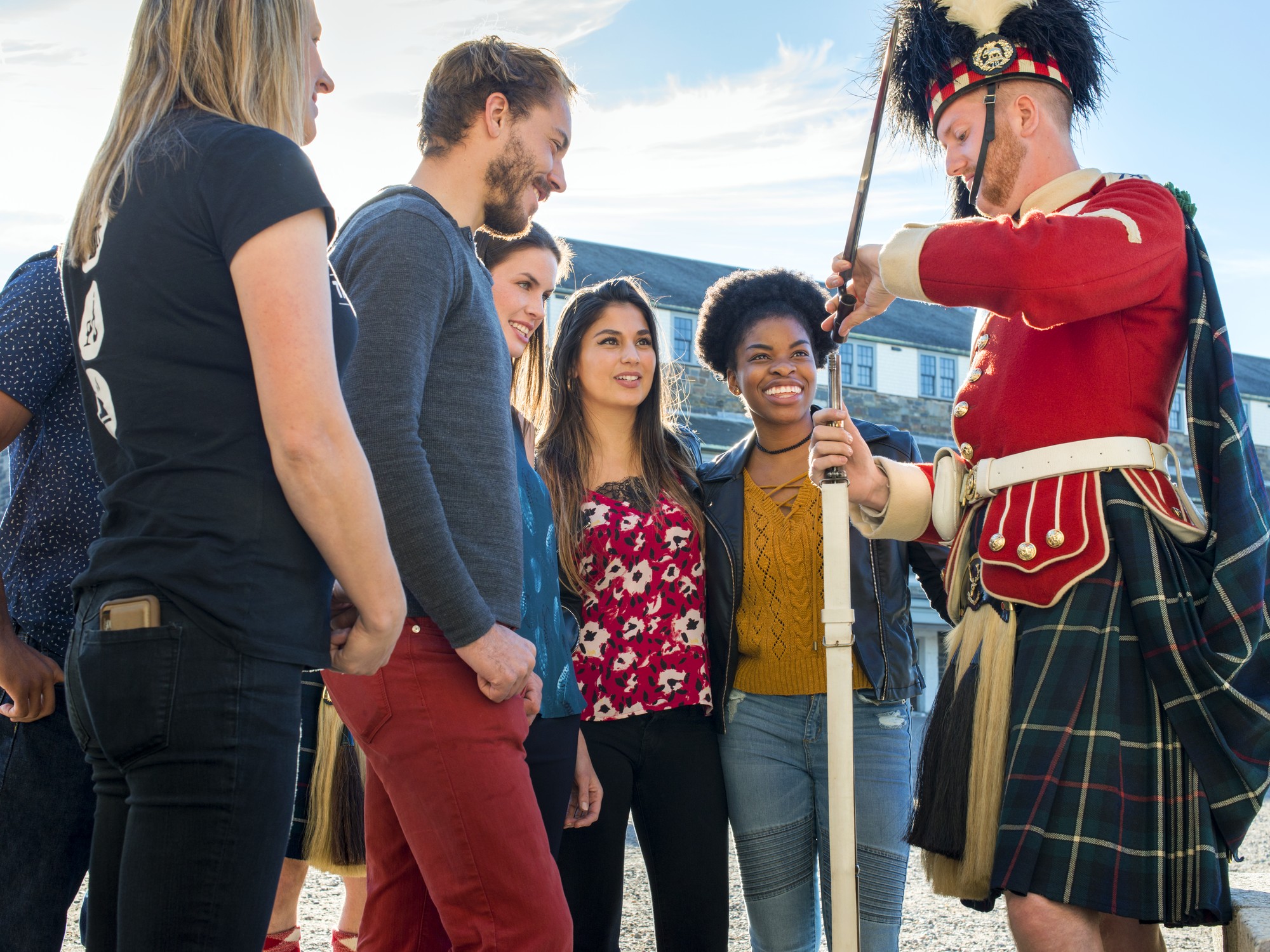 A group interacts with a Highlander at Halifax Citadel National Historic Site