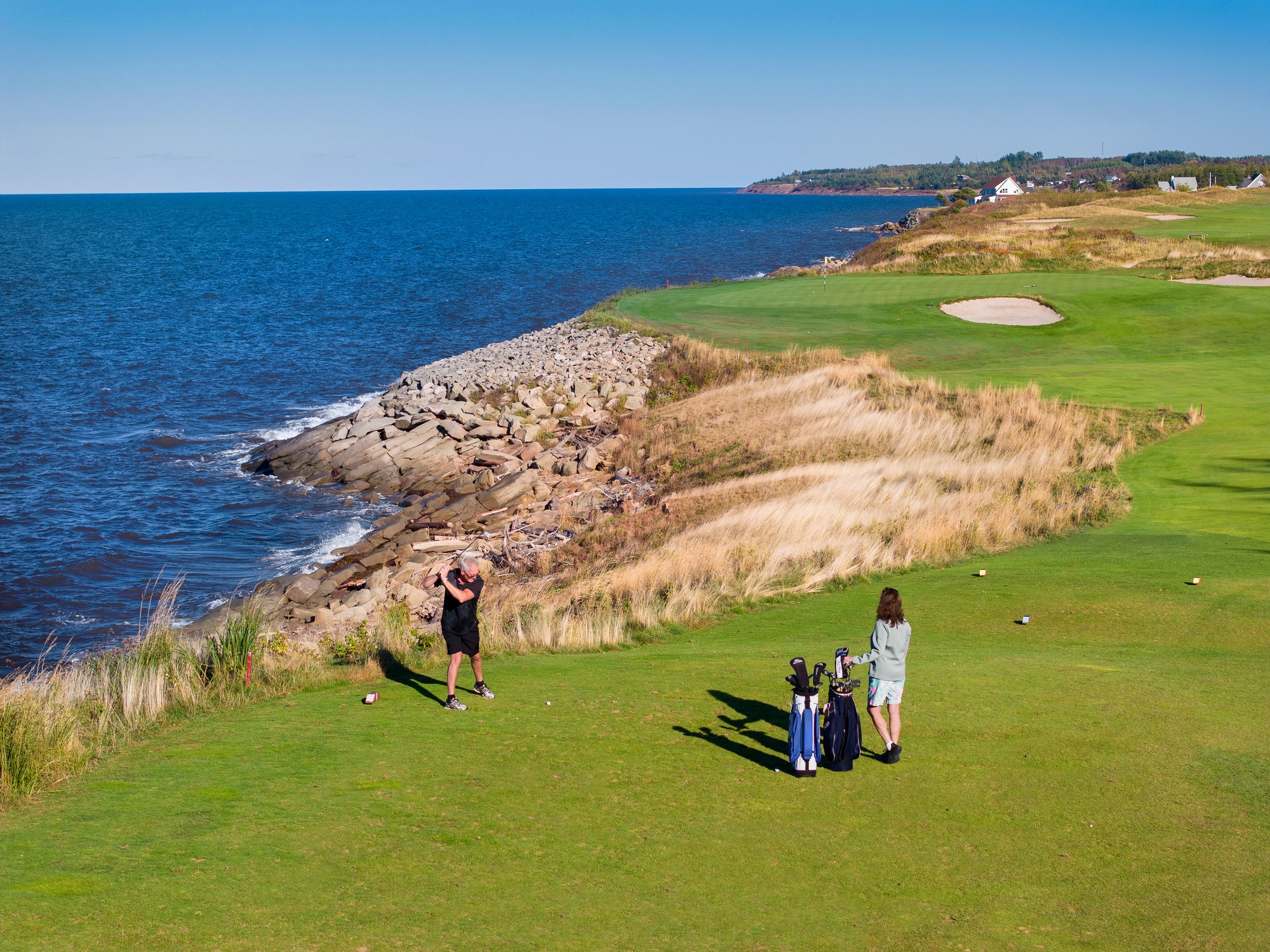 Two golfers play a round at Northumberland Links near Pugwash, Nova Scotia