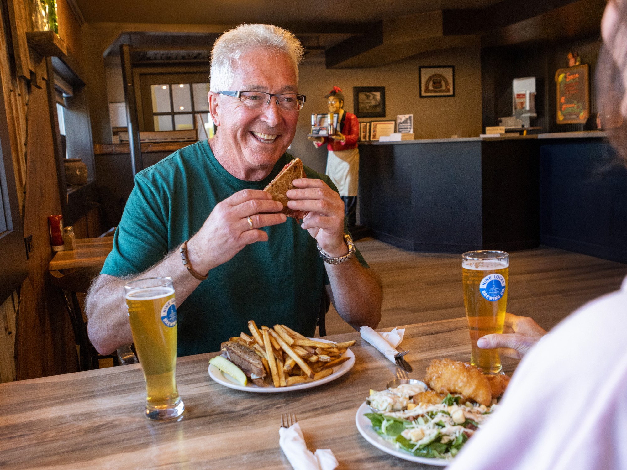 A man is about to take a bite out of a sandwich at Route 6 Roadhouse in Pugwash, Nova Scotia