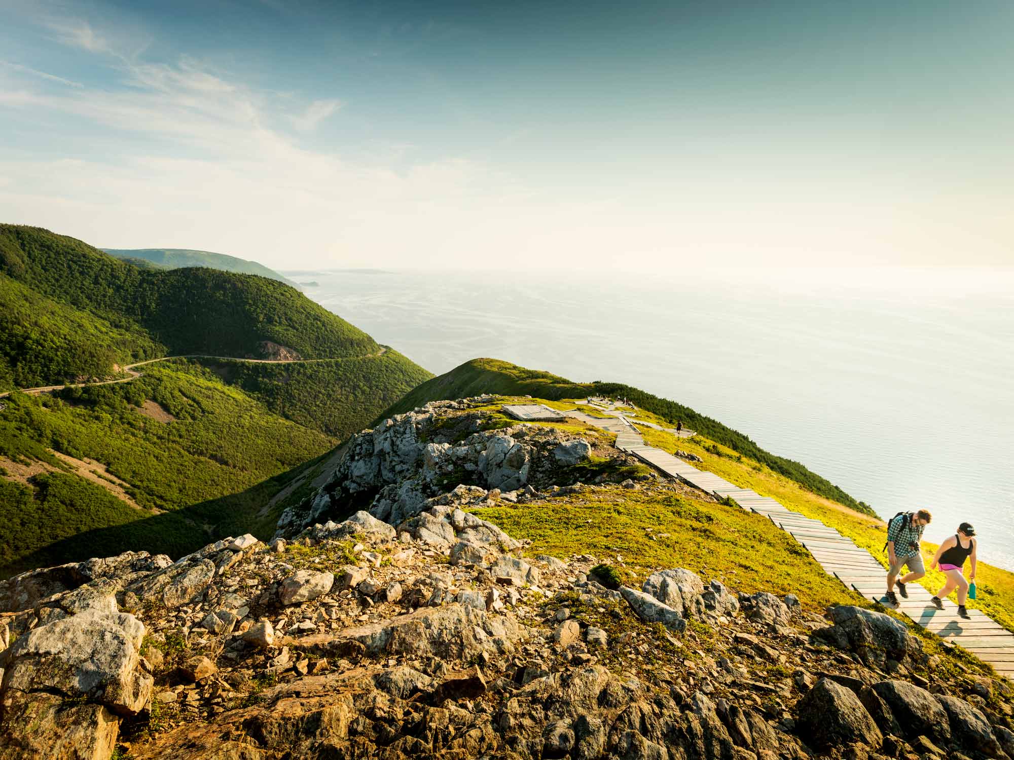 A couple of hikers walking back up the headland boardwalk steps at the tip of the Skyline Trail in the Cape Breton Highlands National Park in Nova Scotia.