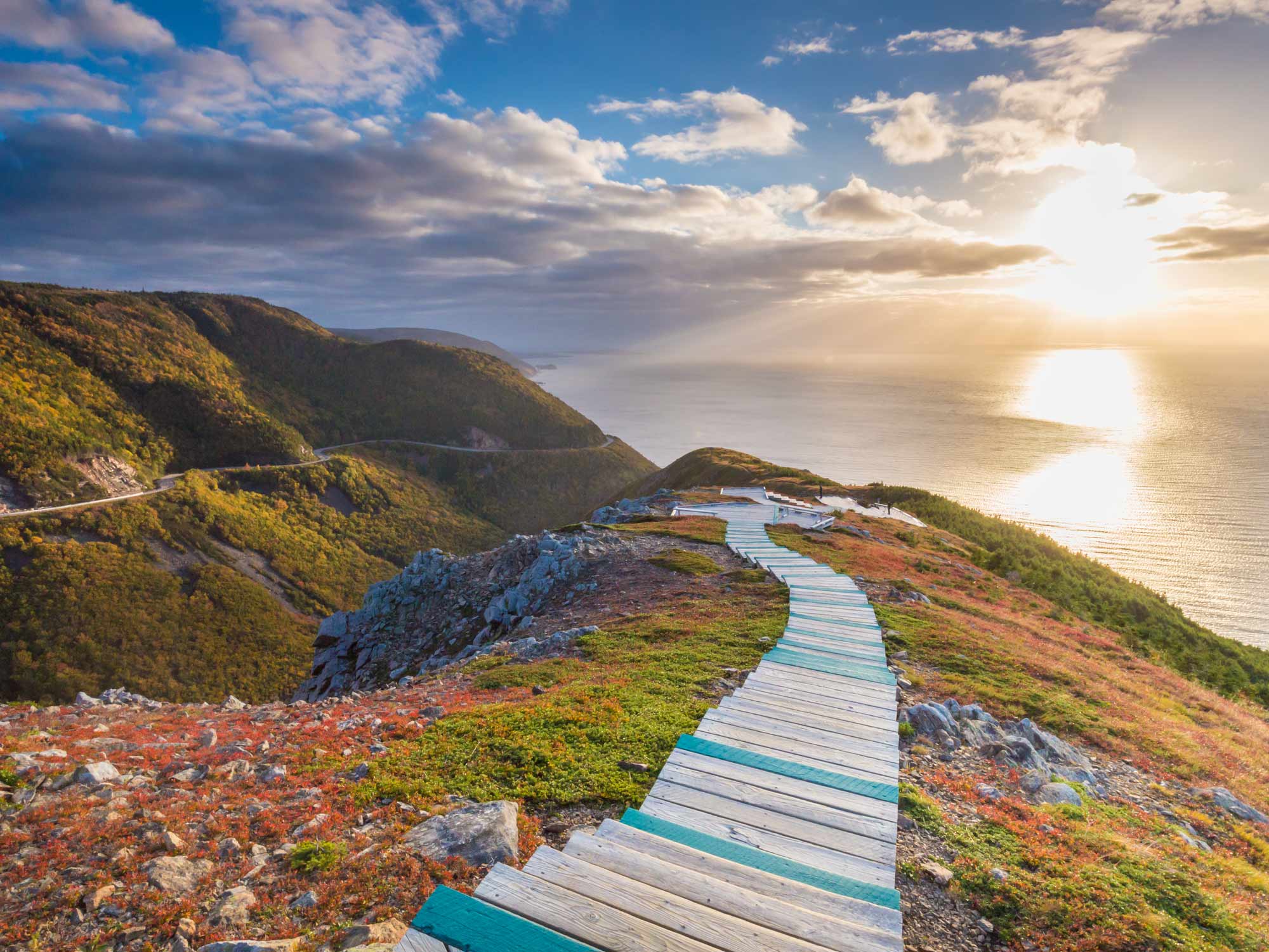 Sun setting over the Northumberland Strait in early Fall from the headland at the tip of the Skyline Trail in the Cape Breton Highlands National Park in Nova Scotia.