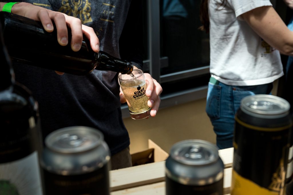A person pours a glass of cider at the Cider Fest in Halifax, Nova Scotia