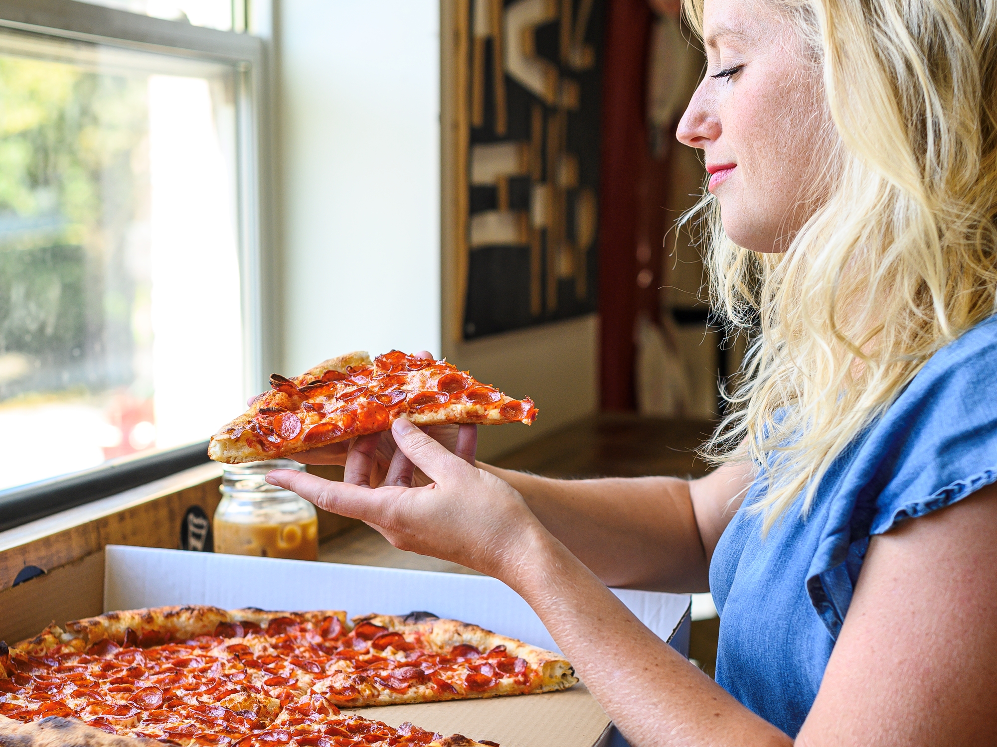Person looking at a large slice of pizza