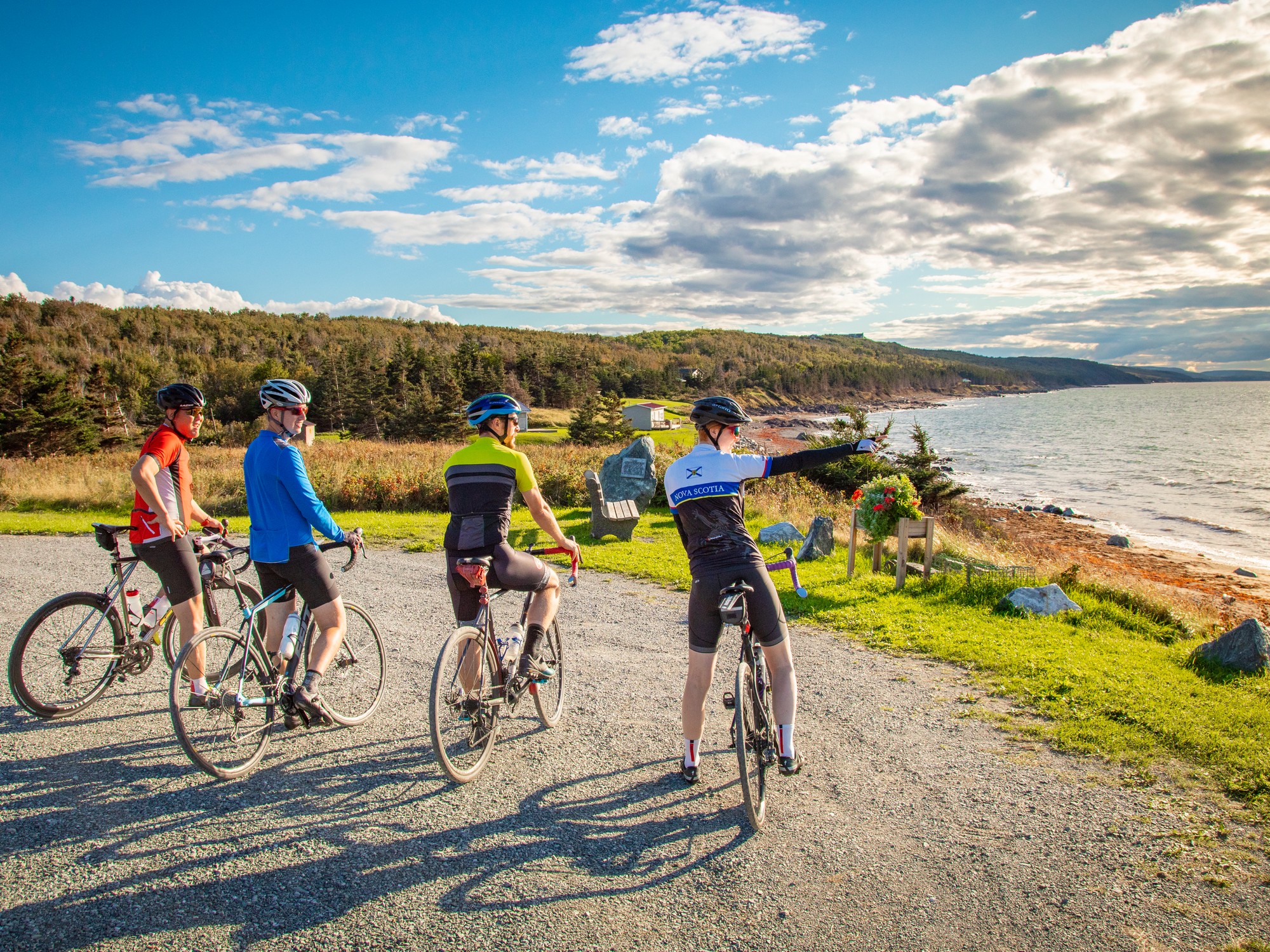 Four cyclists check out the view at Livingston's Cove Wharf Park in Nova Scotia