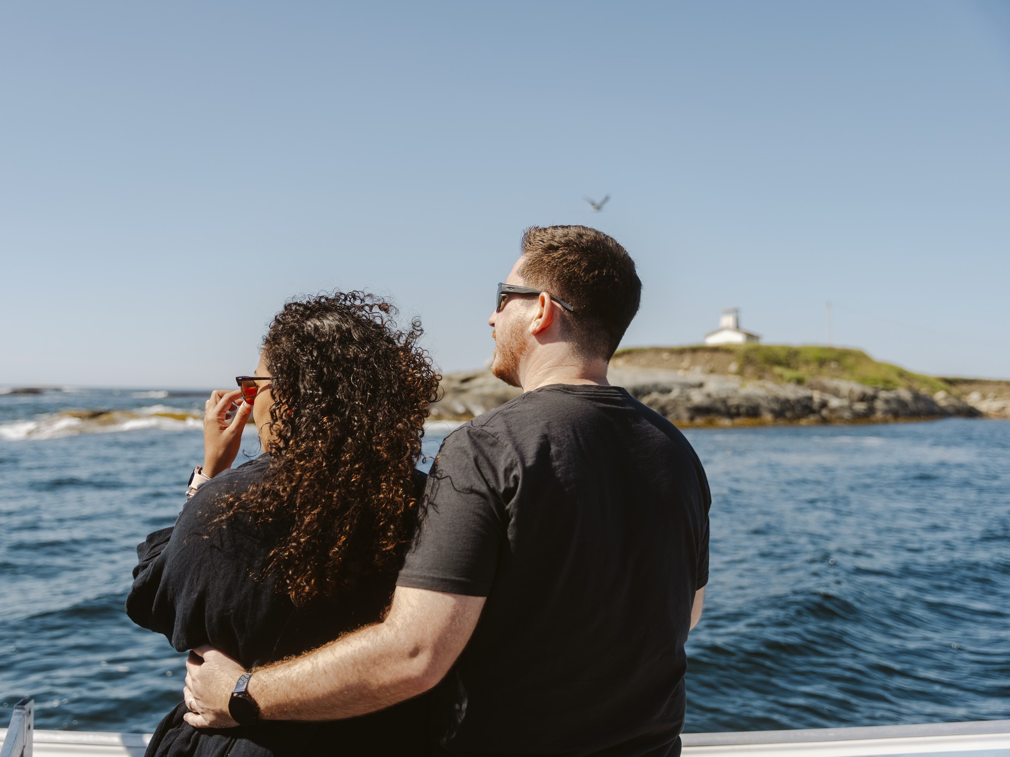 A couple enjoys a boat tour with NovaNature Adventures in Nova Scotia.