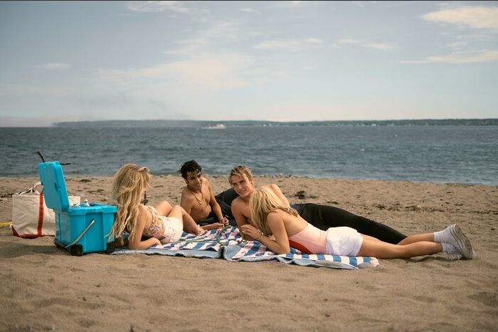 Cast of We Were Liars during a beach scene shot in Nova Scotia