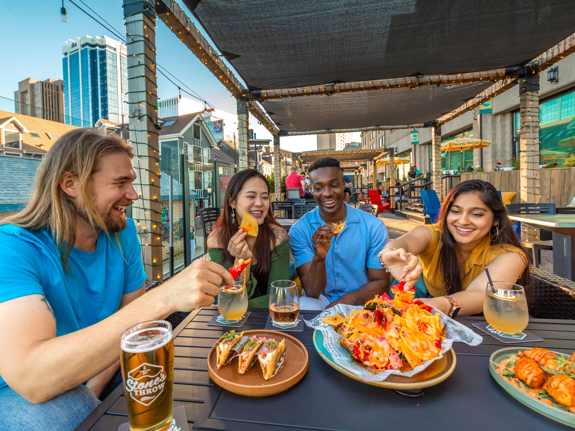 Group of friends enjoying nachos on the patio