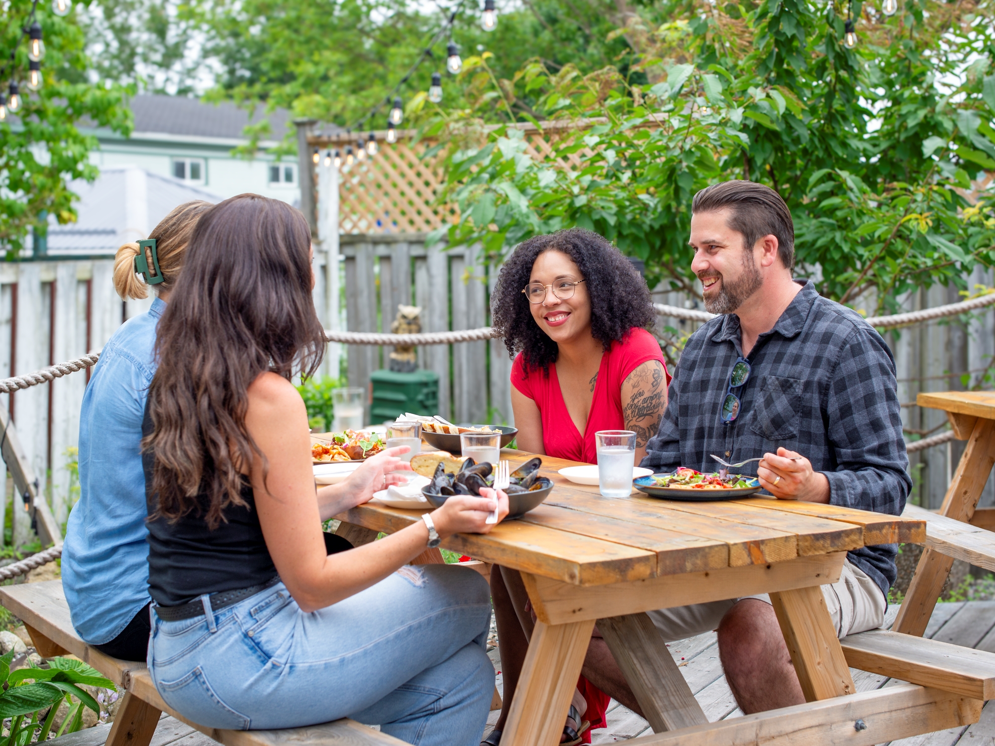 Group of people enjoying a meal on a patio