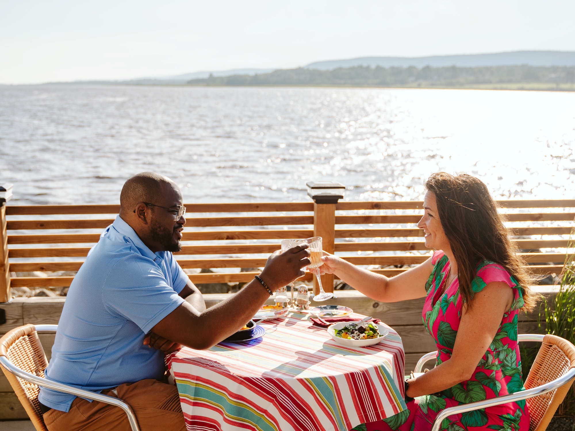 People enjoying a meal next to the water