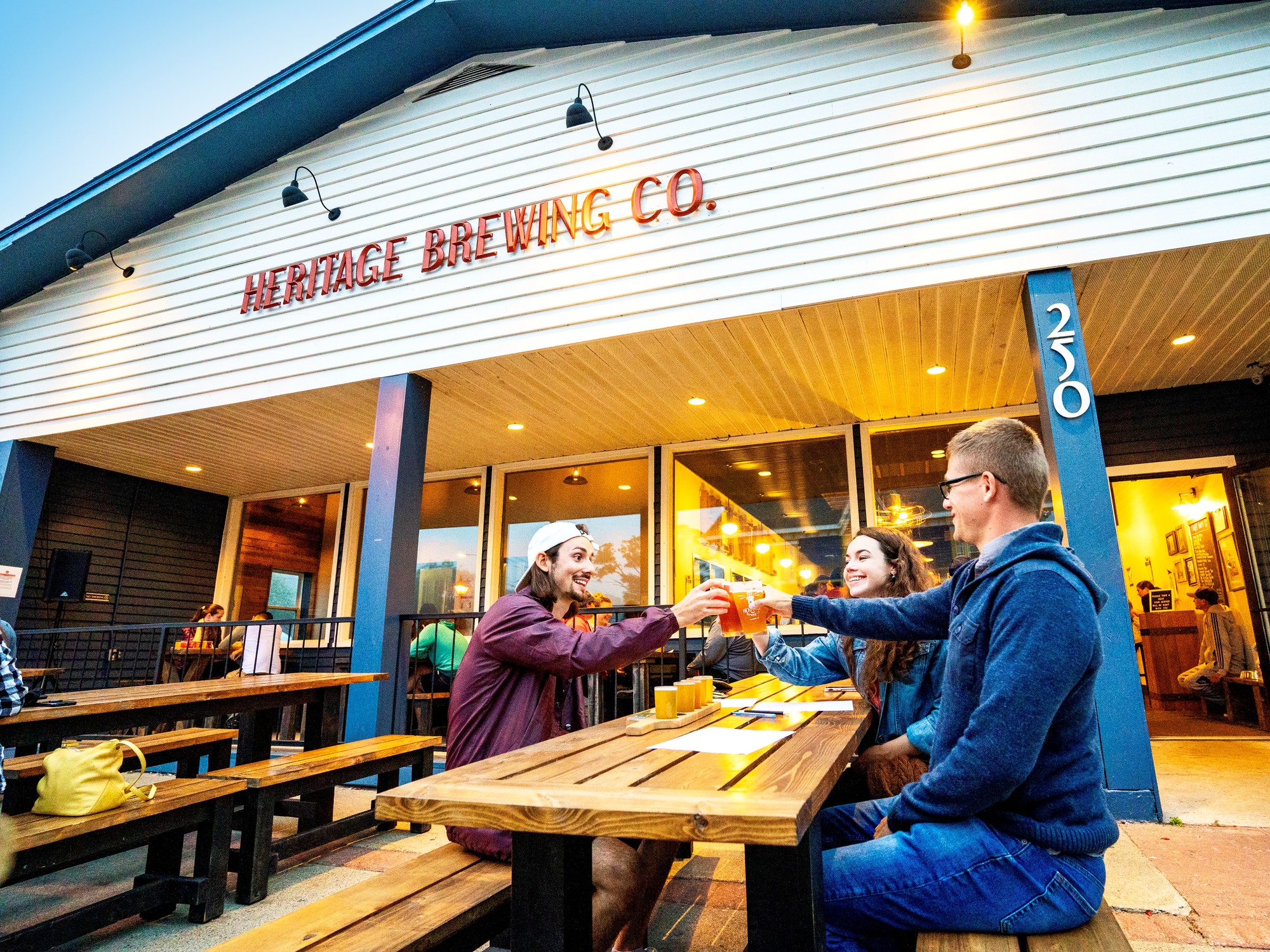 People enjoying an evening on a brewery patio