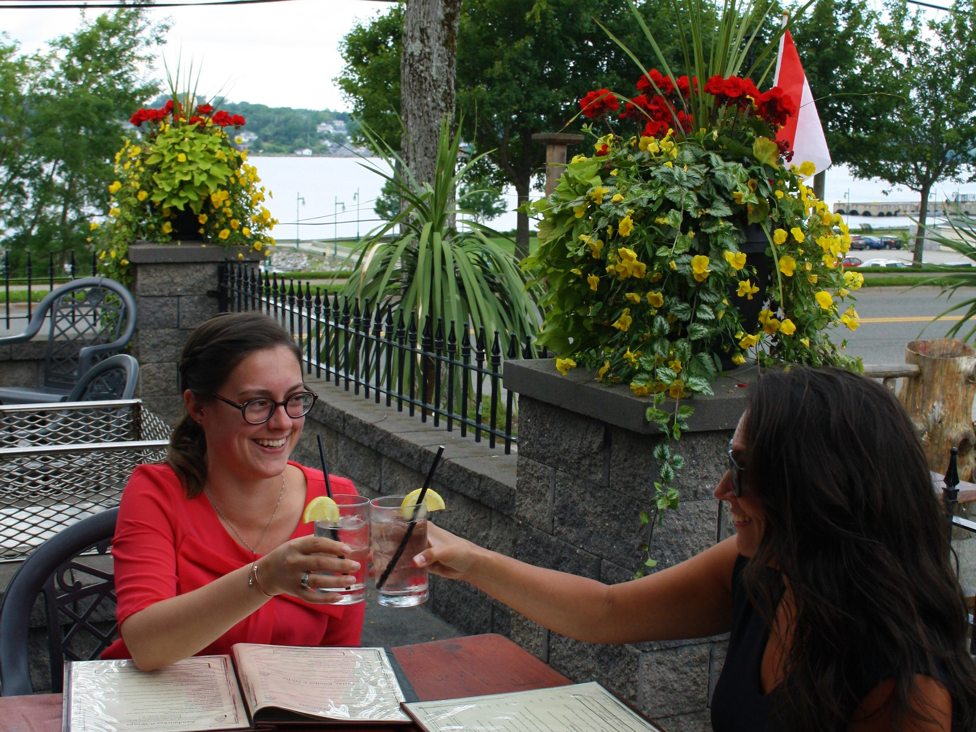 People sitting on a patio with lots of plants in the background