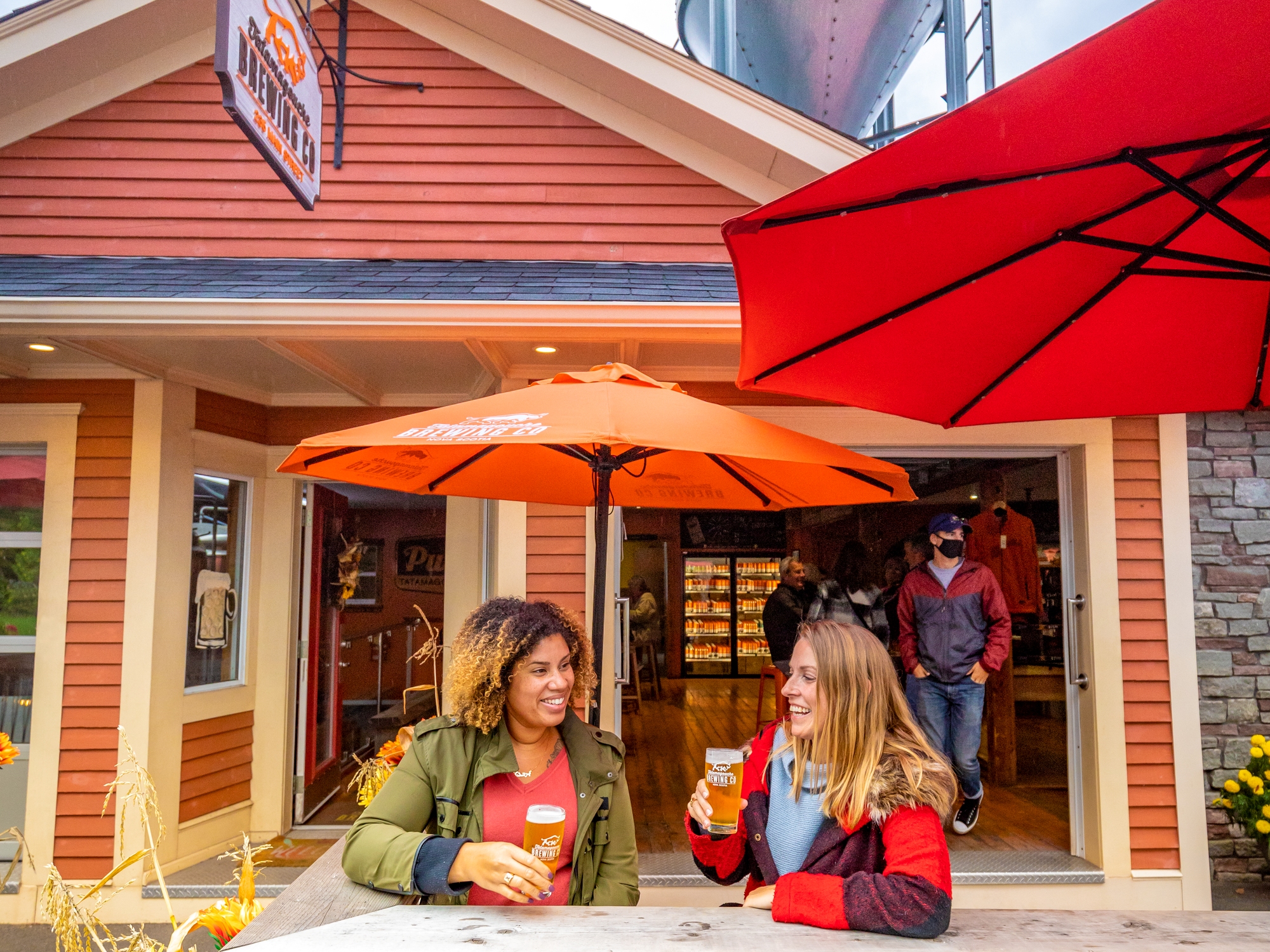 Two people enjoying beer on a patio